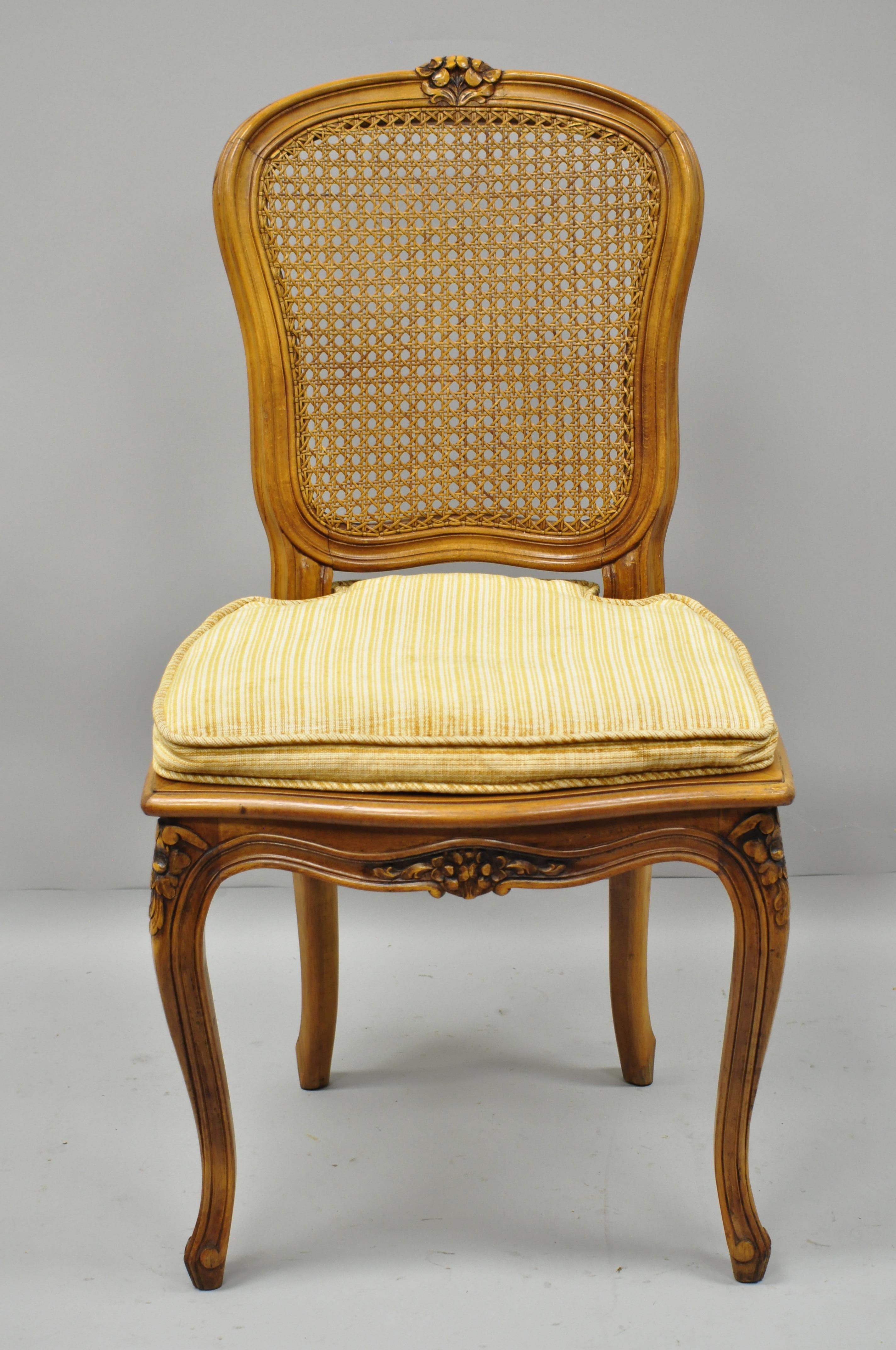 Set of six Italian cane back and seat dining side chairs. Listing includes six armless side chairs, cane back and seats, loose cushions, lightly distressed finish, solid wood construction, nicely carved details, cabriole legs, and great style and