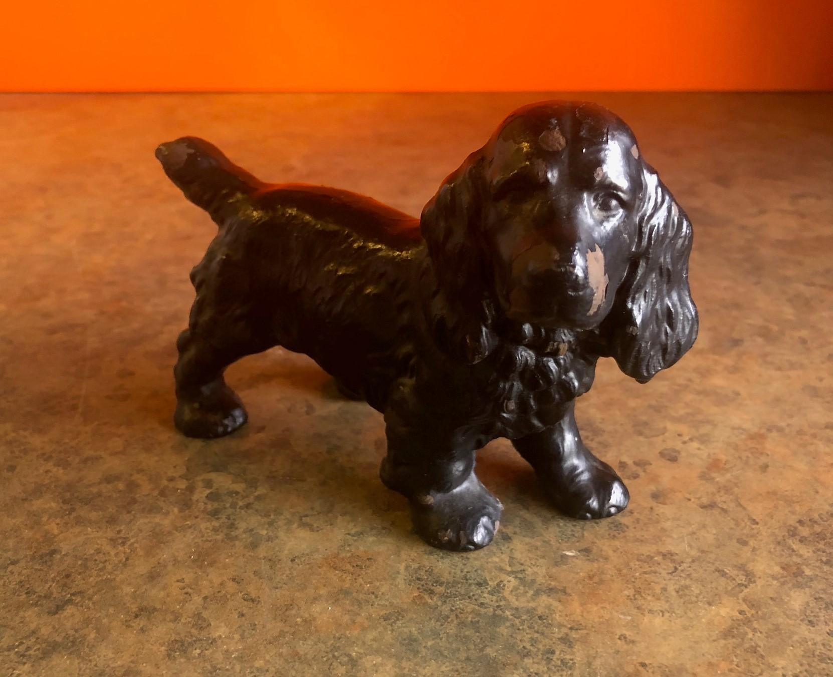 A wonderful Hubley cast iron full figured black Cocker Spaniel dog doorstop, circa 1930s. Doorstop measures 4 1/2