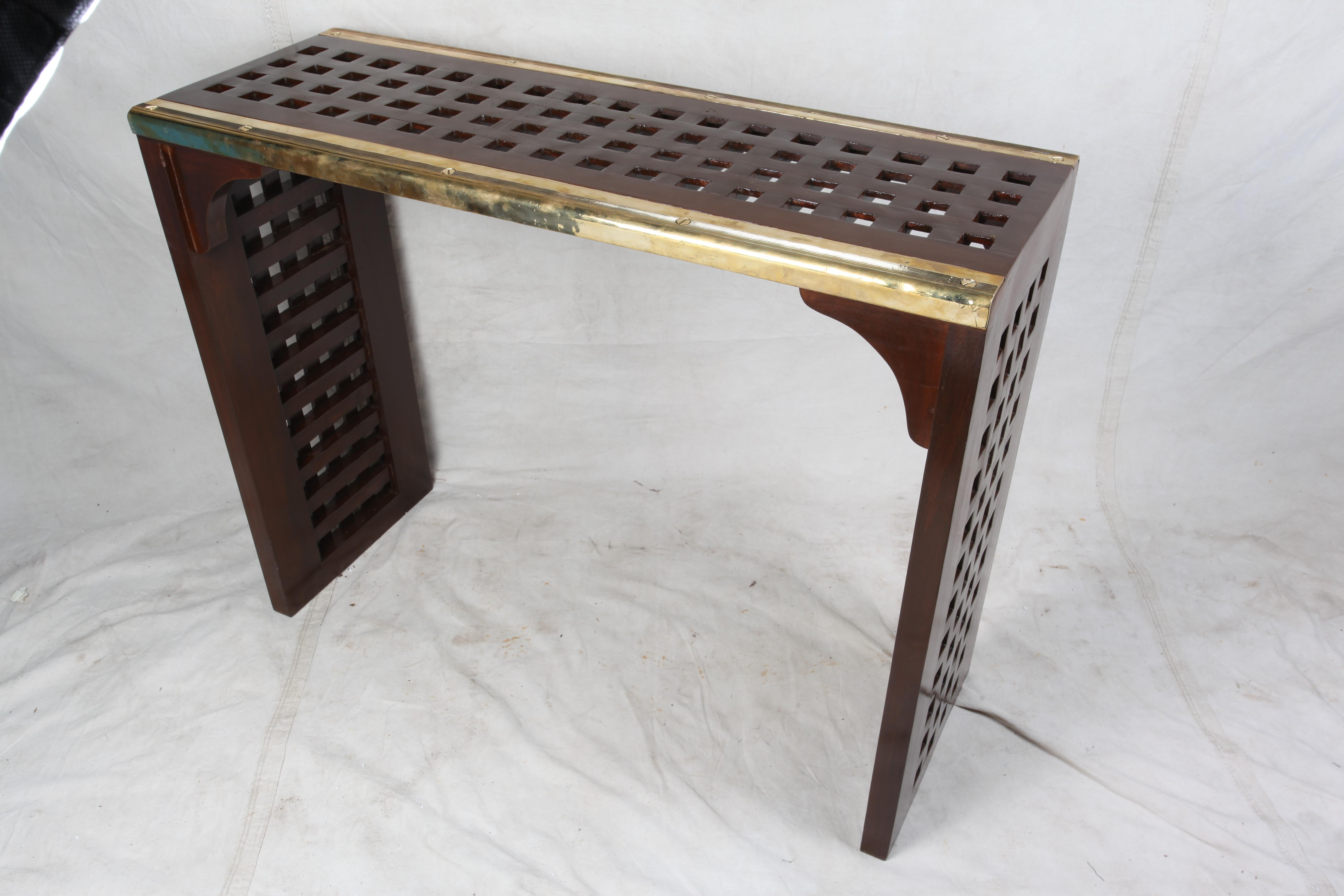 Original ship's teak decking converted to a console table with old brass stair treads used along the edges. Designed by Deborah Lockhart Phillips. A great re-purposing of both the teak decking and brass stair treads. Parts originally from the 1960s.