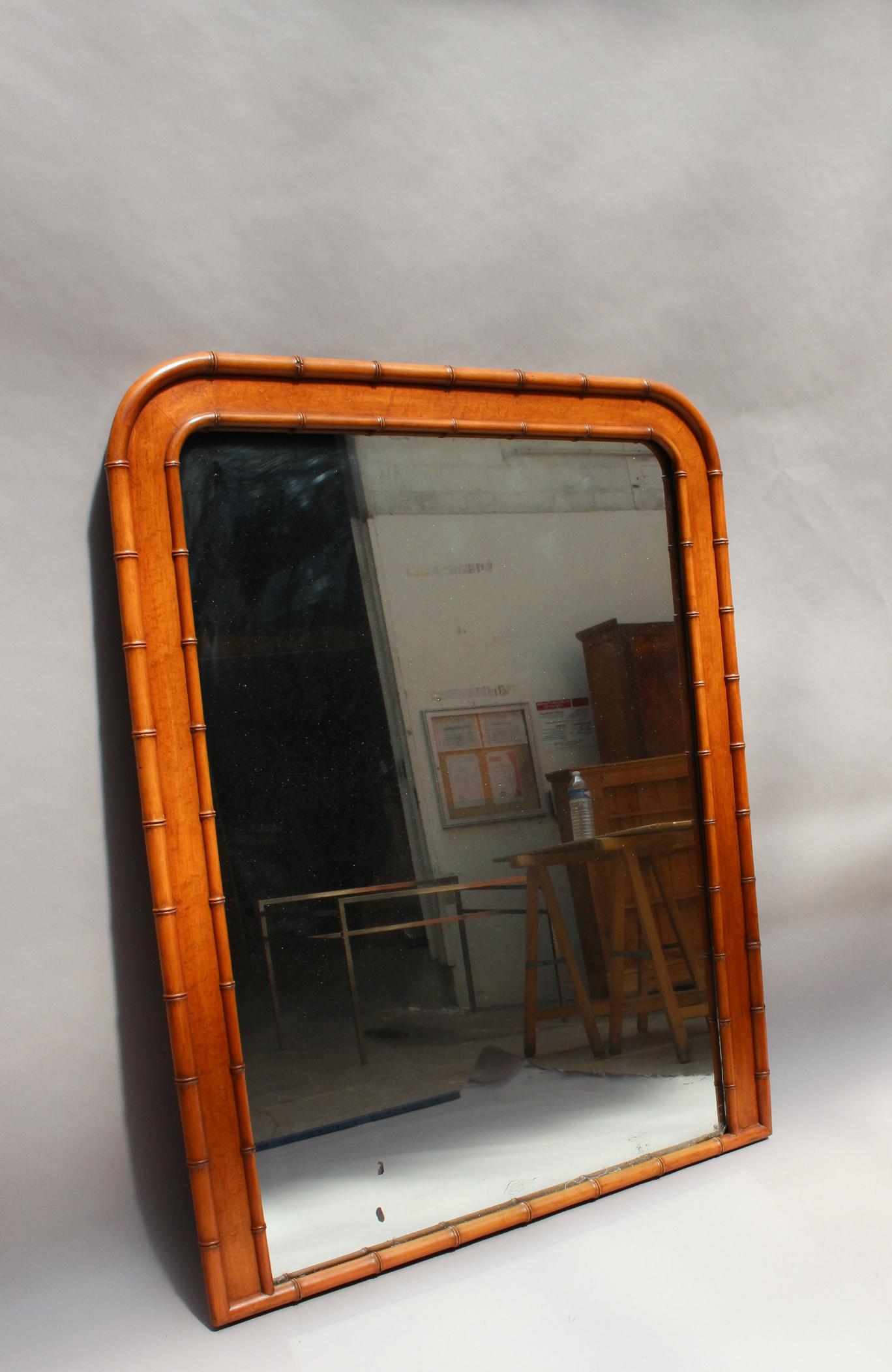 A Fine French Napoleon III faux bamboo and mahogany framed mirror.