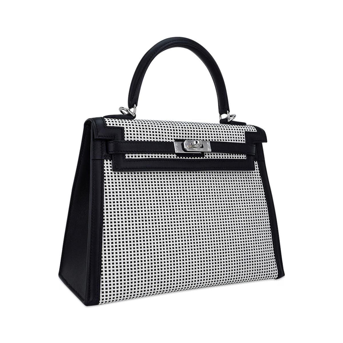 Mightychic offers an exquisite Hermes Kelly Quadrille 25 Sellier bag featured in crisp Black and White Viking toile.
Very rare to  find in the 25 cm size.
Accentuated with palladium hardware and Black Swift leather.
Comes with signature Hermes