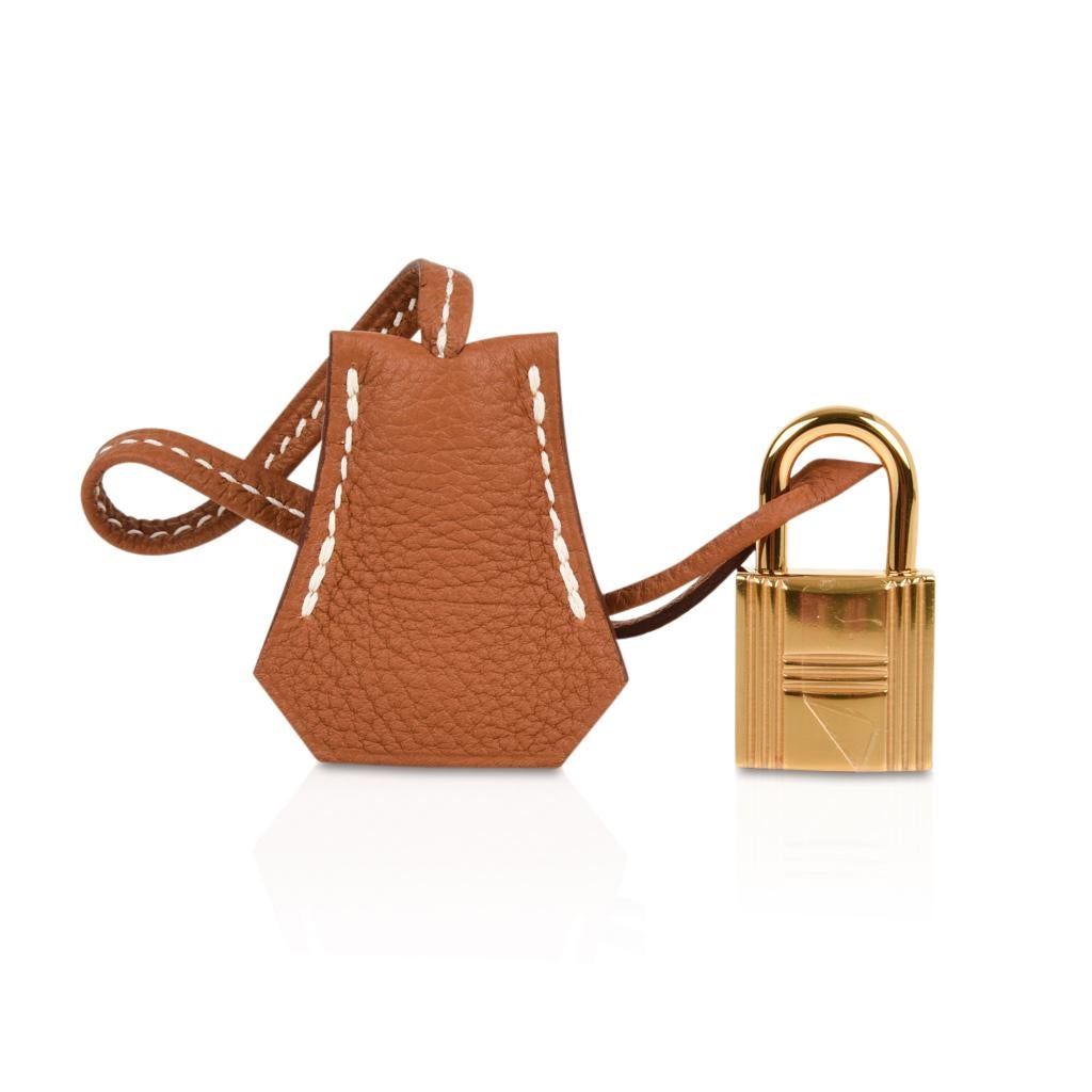Guaranteed authentic Hermes Kelly 25 Retourne bga  features coveted classic Gold in togo leather.
Lush with Gold hardware.   
Comes with lock, keys, clochette, sleepers, raincoat and signature Hermes box.
NEW or NEVER WORN.
final sale

BAG
