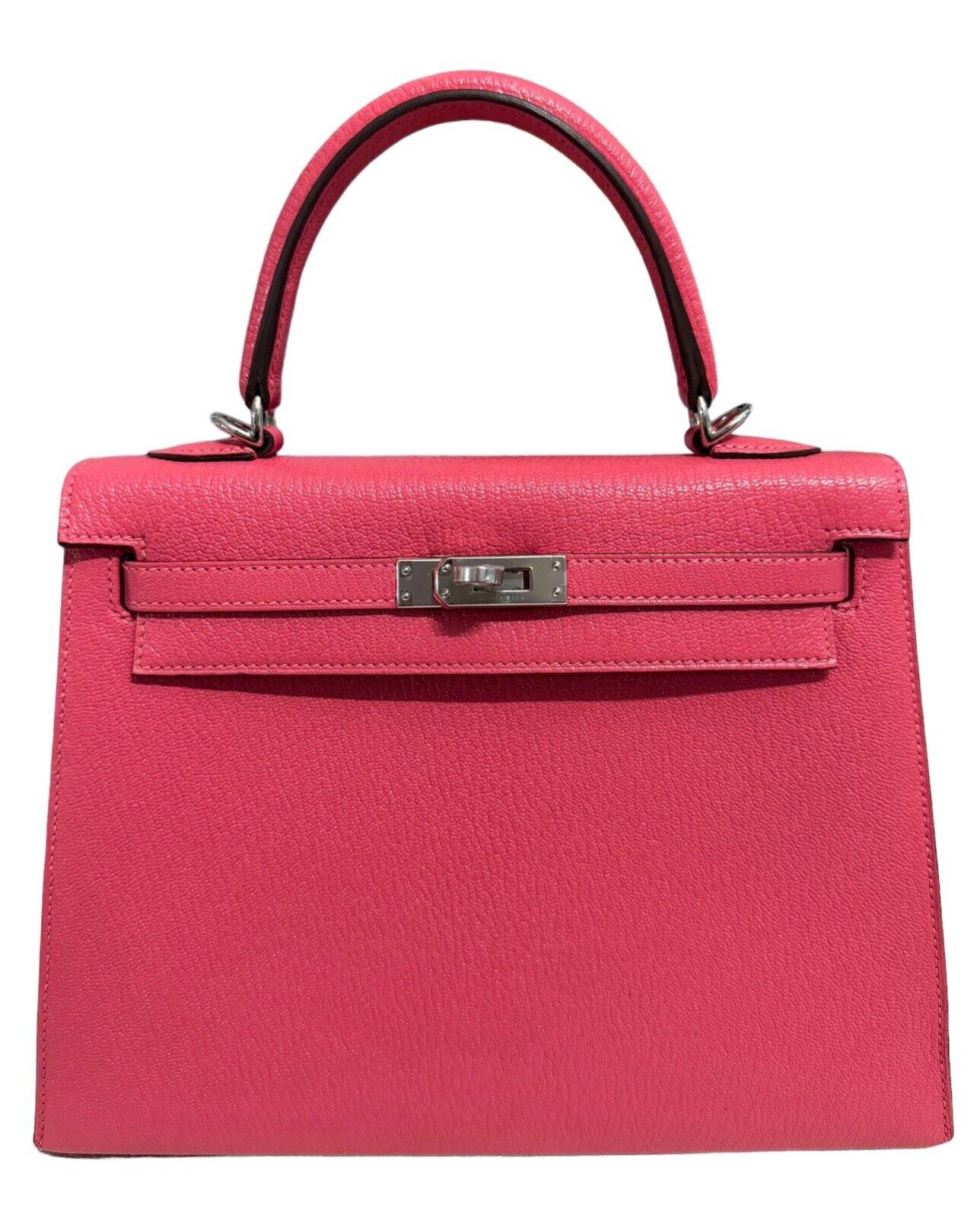 As New RARE Most Coveted Hermes Kelly 25 Sellier Rose Azalee Chèvre Leather , Complimented by Palladium Hardware. AS NEW Y STAMP 2020. Bag Has a minor scratch on the exterior of the INSIDE pocket due to the strap, lock and keep being shipped loose