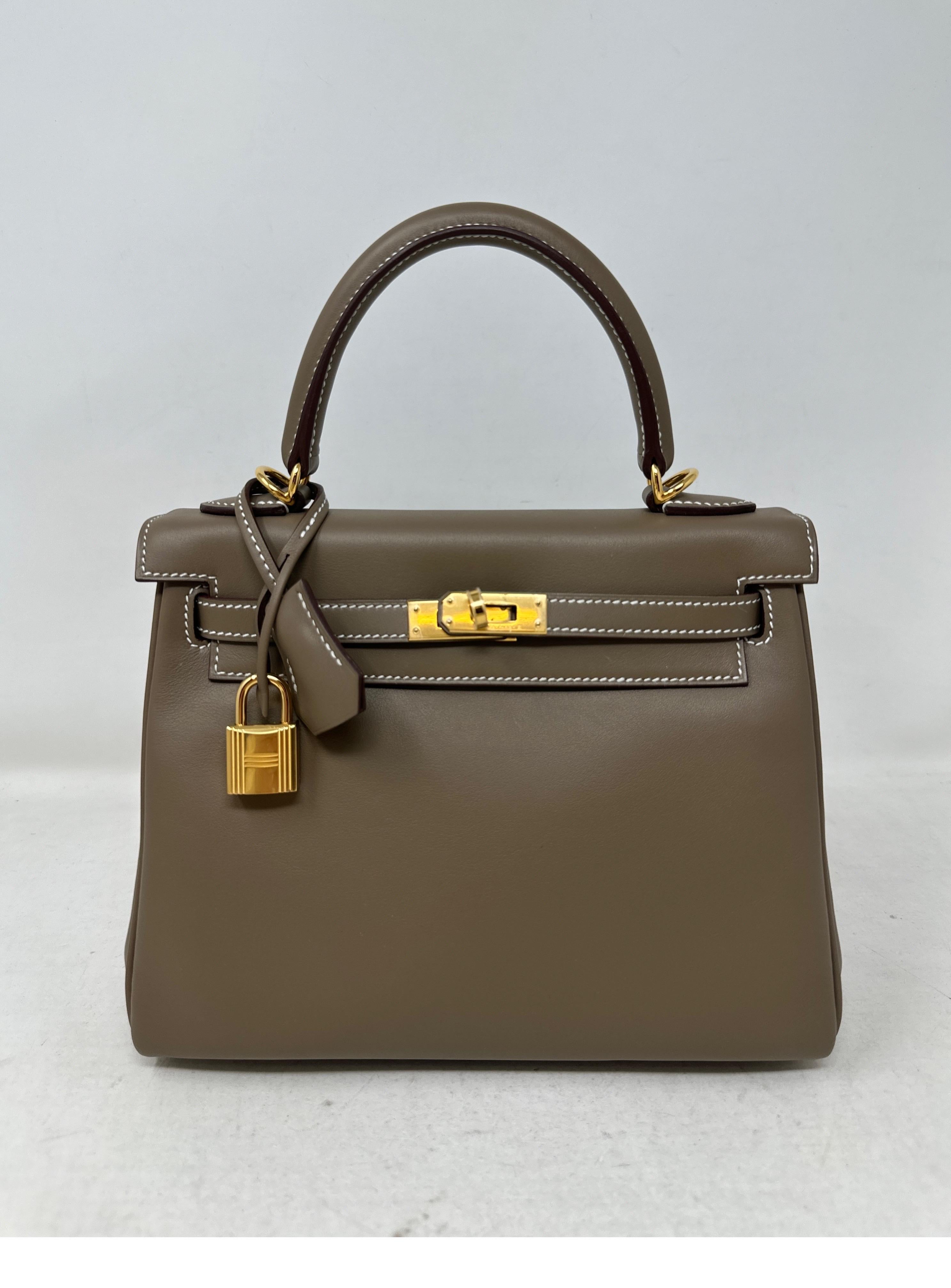 Hermes Etoupe Swift Kelly 25 Bag. Brand new 2023 Kelly 25 Bag. Stunning smooth swift leather. Hard to get etoupe color. Great neutral color. Gold hardware. Rare small size 25 Kelly. Includes full set with original receipt. Box and dust bag included.