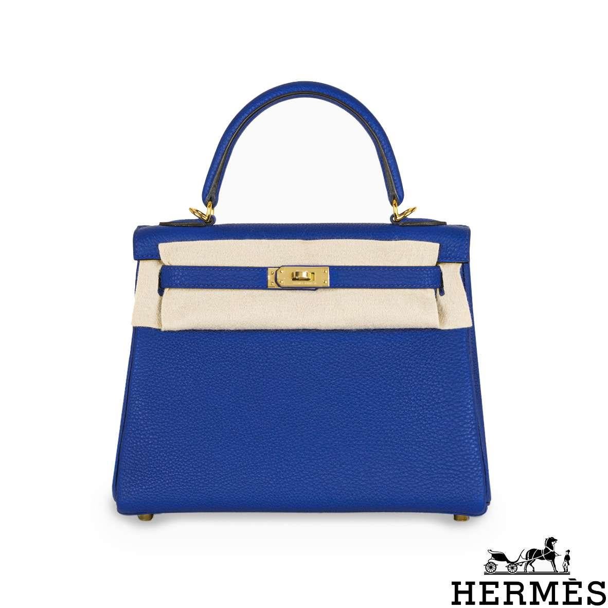 A beautiful Hermès 25cm Kelly bag. The exterior of this Kelly features a Retourne style in Bleu Royal Veau Togo leather. The Bleu Royal Togo leather is complemented with gold-tone hardware and tonal stitchings. It features a front toggle closure