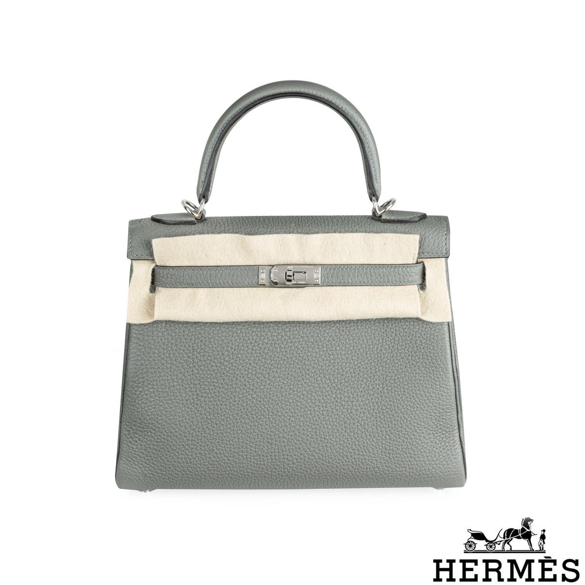 A classic Hermès 25cm Kelly bag. The exterior of this Kelly features a Retourne style in Gris Meyer Veau Togo leather. The Gris Meyer Togo leather is complemented with palladium hardware and tonal stitchings. It features a front toggle closure with