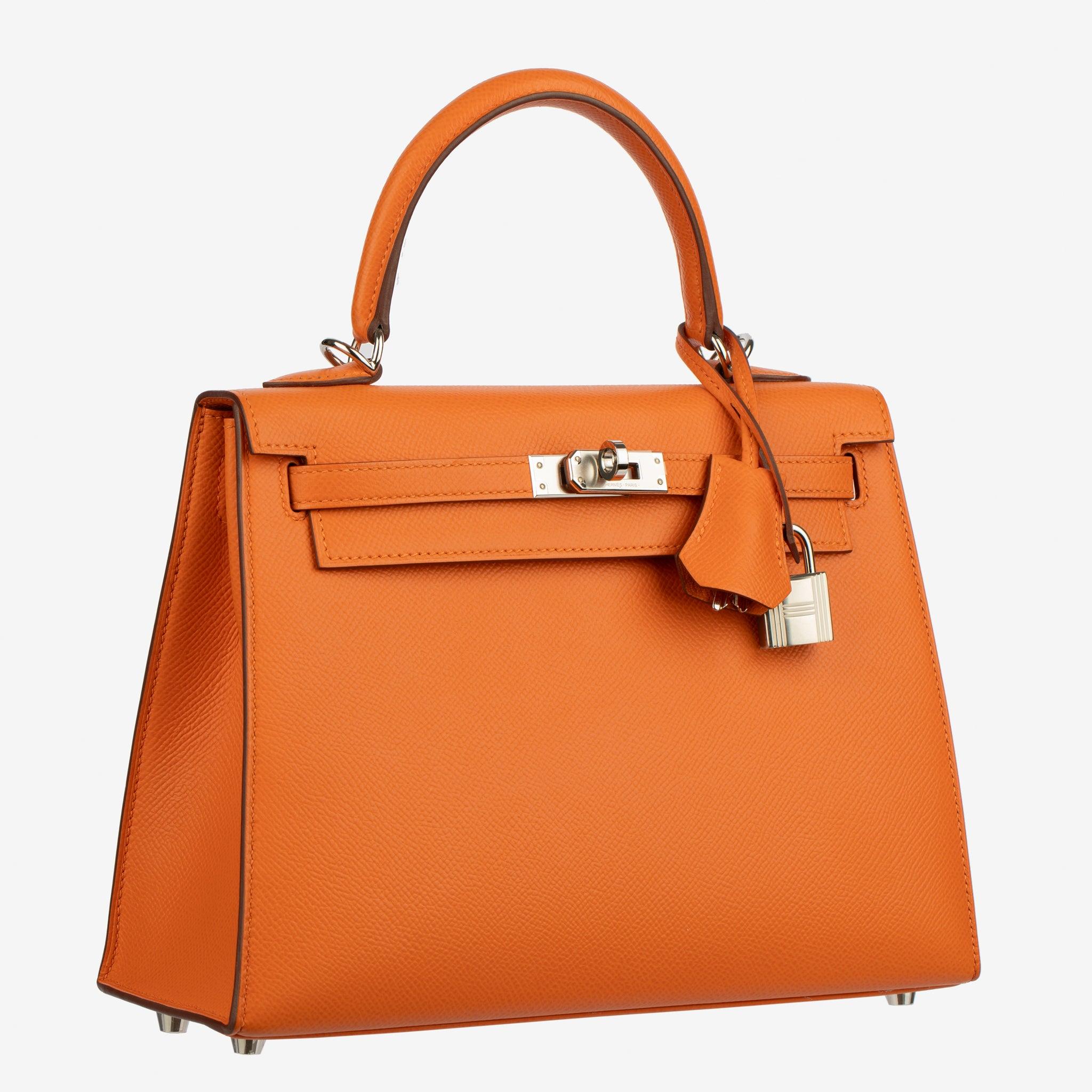 A timeless emblem of Hermès craftsmanship, the Kelly Sellier 25 is renowned for its sharp lines, architectural silhouette, and enduring sophistication. Featured in vibrant Orange Epsom leather with palladium hardware, it strikes the perfect harmony