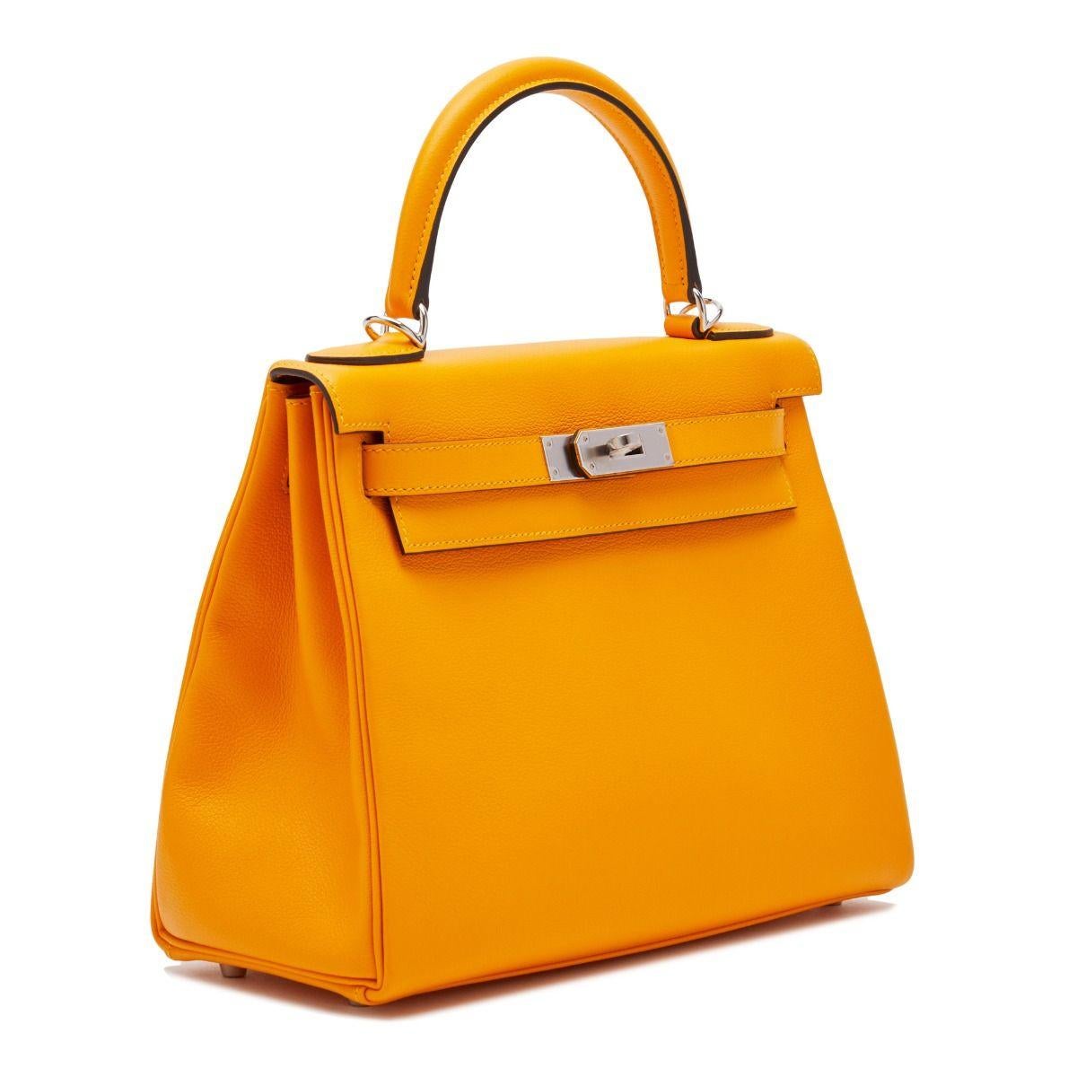 This Hermès Kelly exudes opulence, crafted in a eye-catching shade of Apricot and lined in a complementary toned goatskin and finished with brushed metal palladium hardware. Compact-sized, the handbag's interior holds a zipped pocket and an open