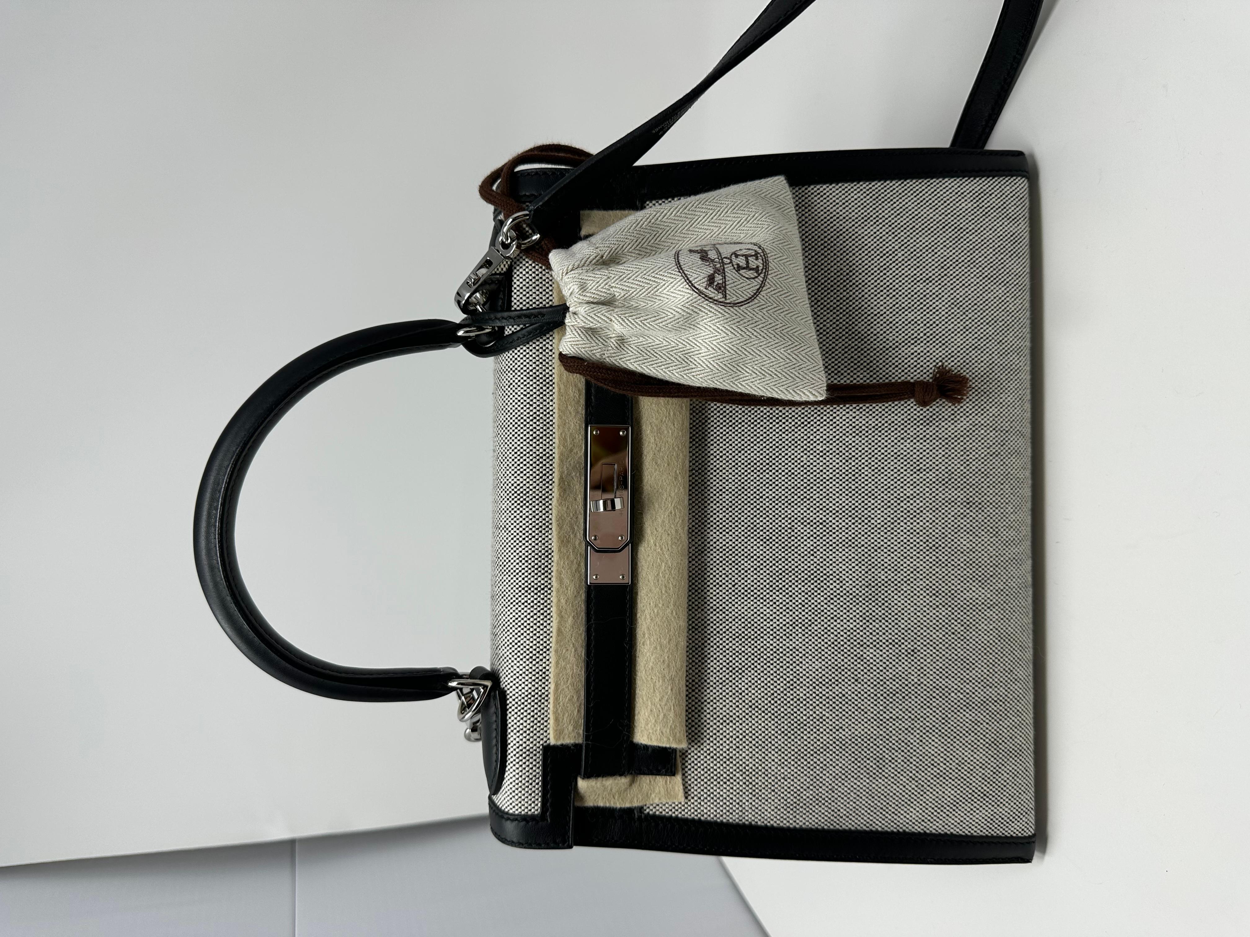 Hermès Black black Swift and Toile Sellier Kelly 28 Palladium Hardware, 2021
The interior is lined in black swift leather
Includes lock, two keys, clochette, clochette dustbag, shoulder strap, shoulder strap dustbag, felt protector, dustbag,