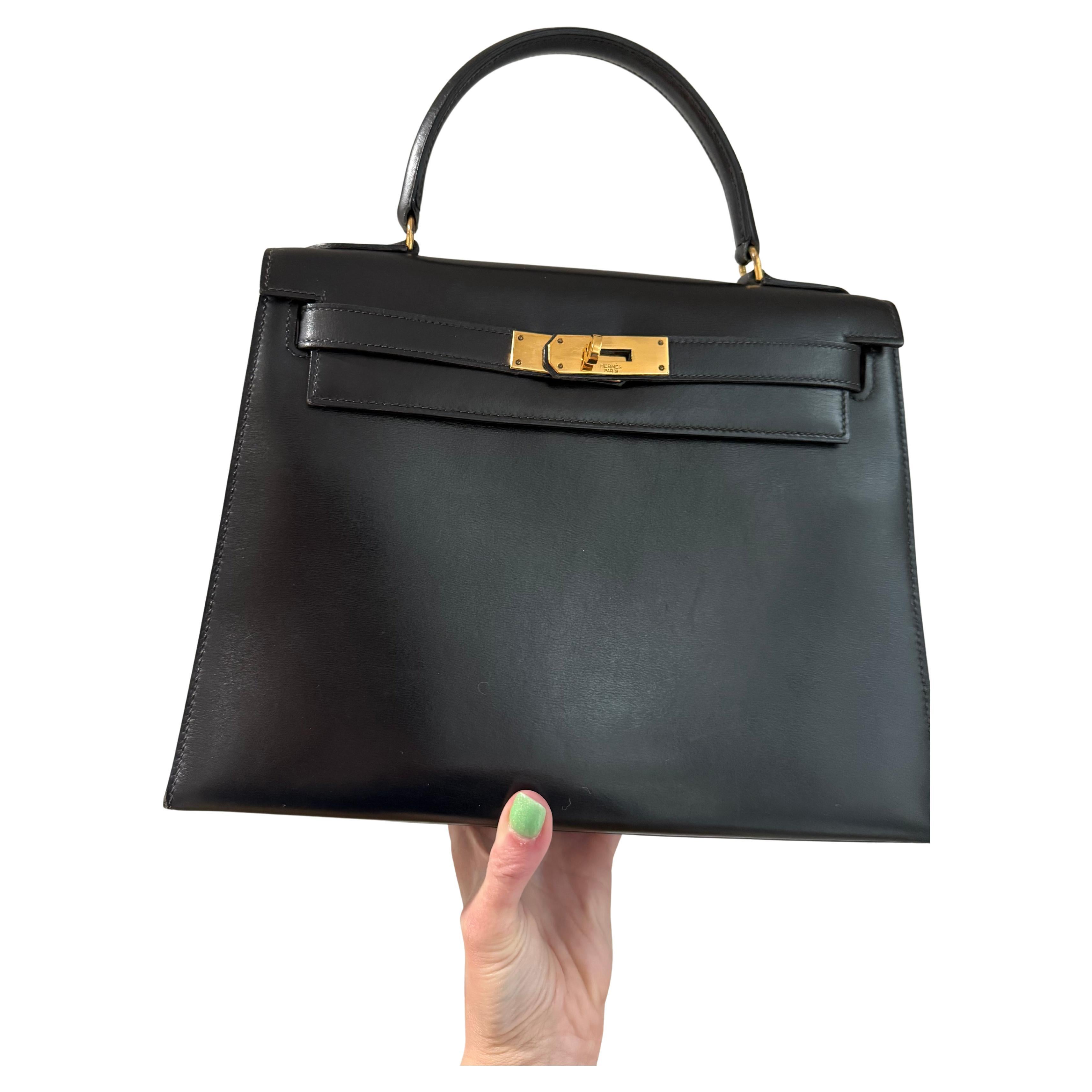 Hermès Kelly 28 handbag in black box calf leather with gold hardware For Sale