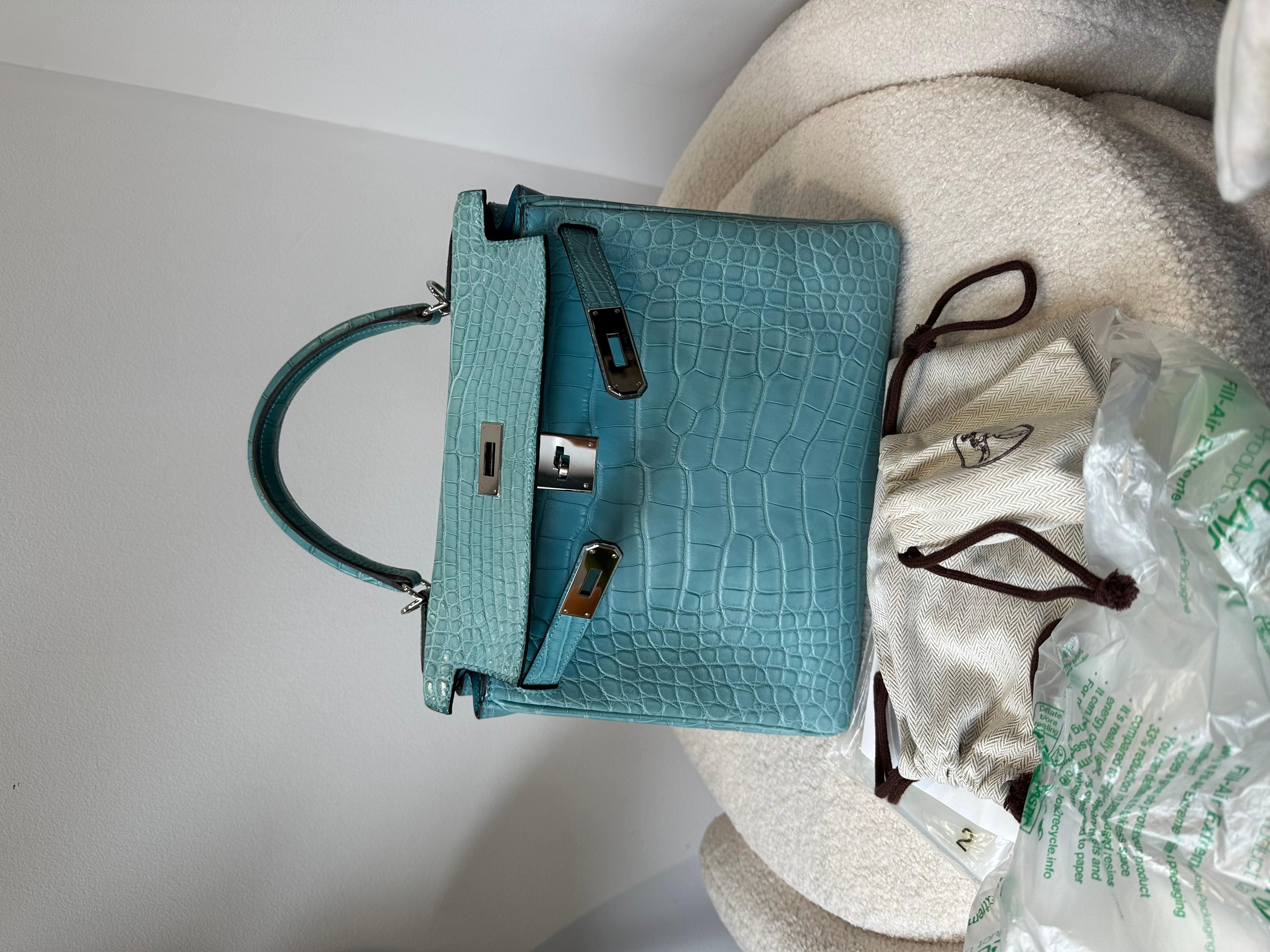 Hermes Kelly 28cm Bleu St Cyr Matte Croc phw bag. 
A simply stunning 28cm Hermes Kelly in Matte alligator in Bleu St Cyr which is slightly muted blue. A really special and rare bag.
In as new condition!

With palladium Hardware, full measurements