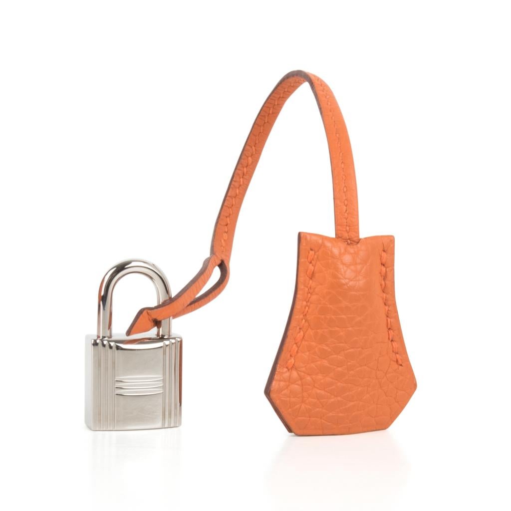 Guaranteed authentic Hermes Kelly 28 retourne bag features H Orange. 
This beautiful iconic Hermes colour is no longer produced.
Togo leather with Palladium Hardware.   
Comes with shoulder strap, sleepers, lock, keys and clochette. 
Hardware is