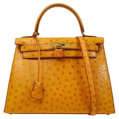 Hermès - Sac fourre-tout Kelly 28 Sellier en autruche cognac et or exotique avec poignée supérieure