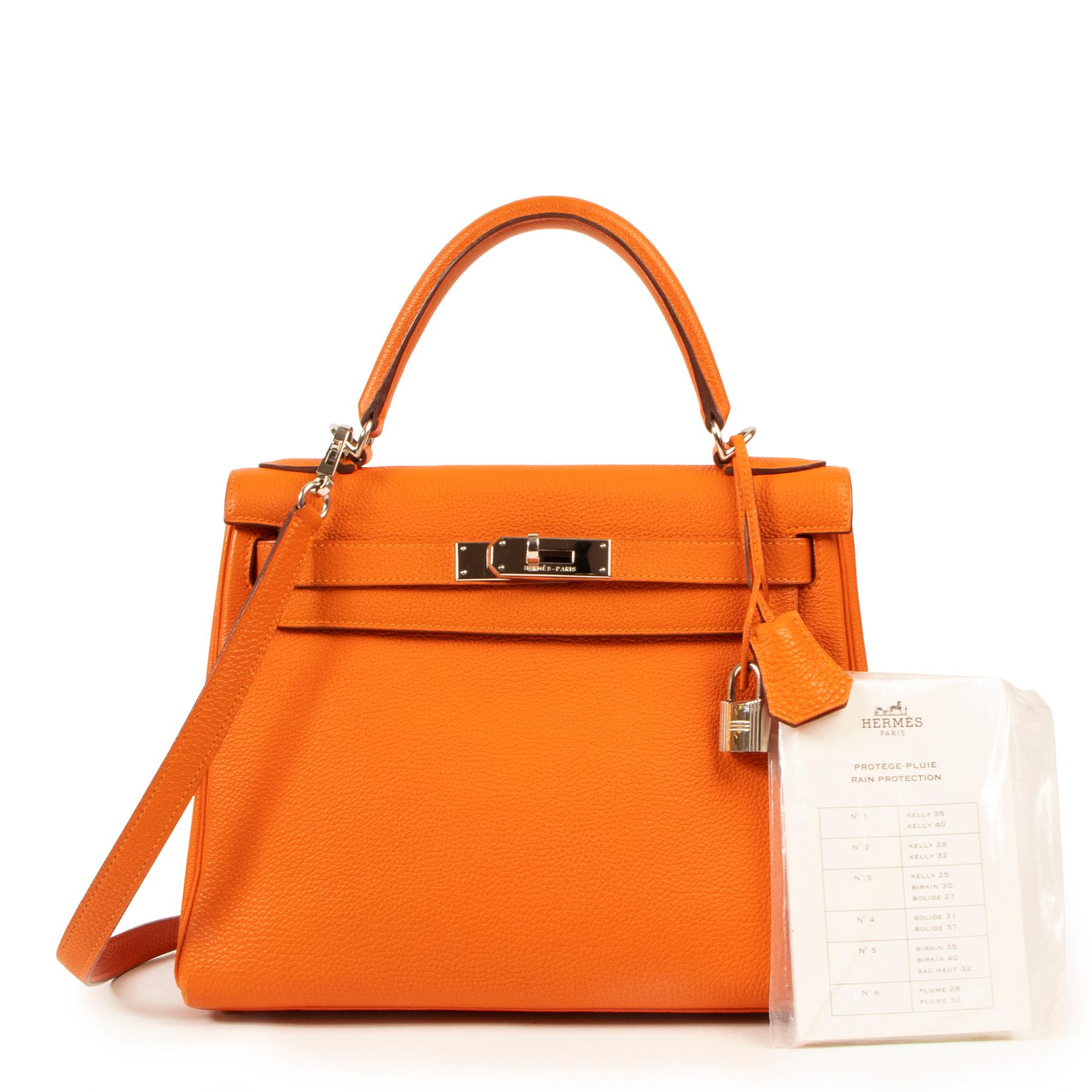 Make heads turn with this stunning Kelly bag.

This beautiful and highly sough-after Hermes Kelly bag is a true icon.

Crafted from gorgeous pebbled togo leather in the iconic Hermes Orange color.

The silver colored hardware makes this bag