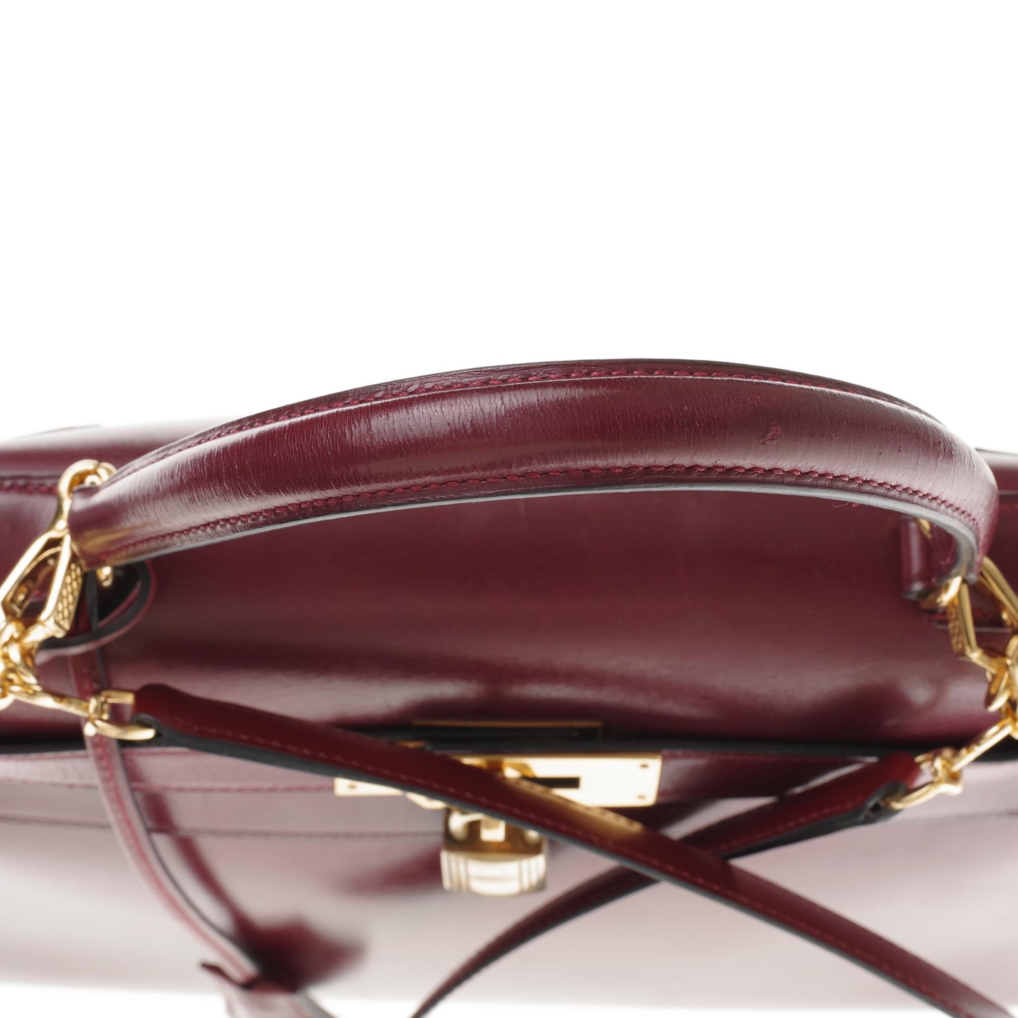 Hermès Kelly 28cm sellier with strap handbag in burgundy calfskin, Gold hardware 1