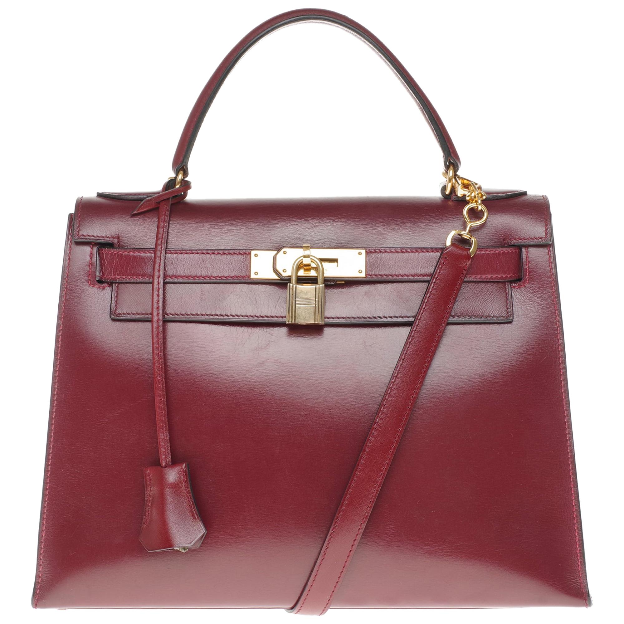 Hermès Kelly 28cm sellier with strap handbag in burgundy calfskin, Gold hardware