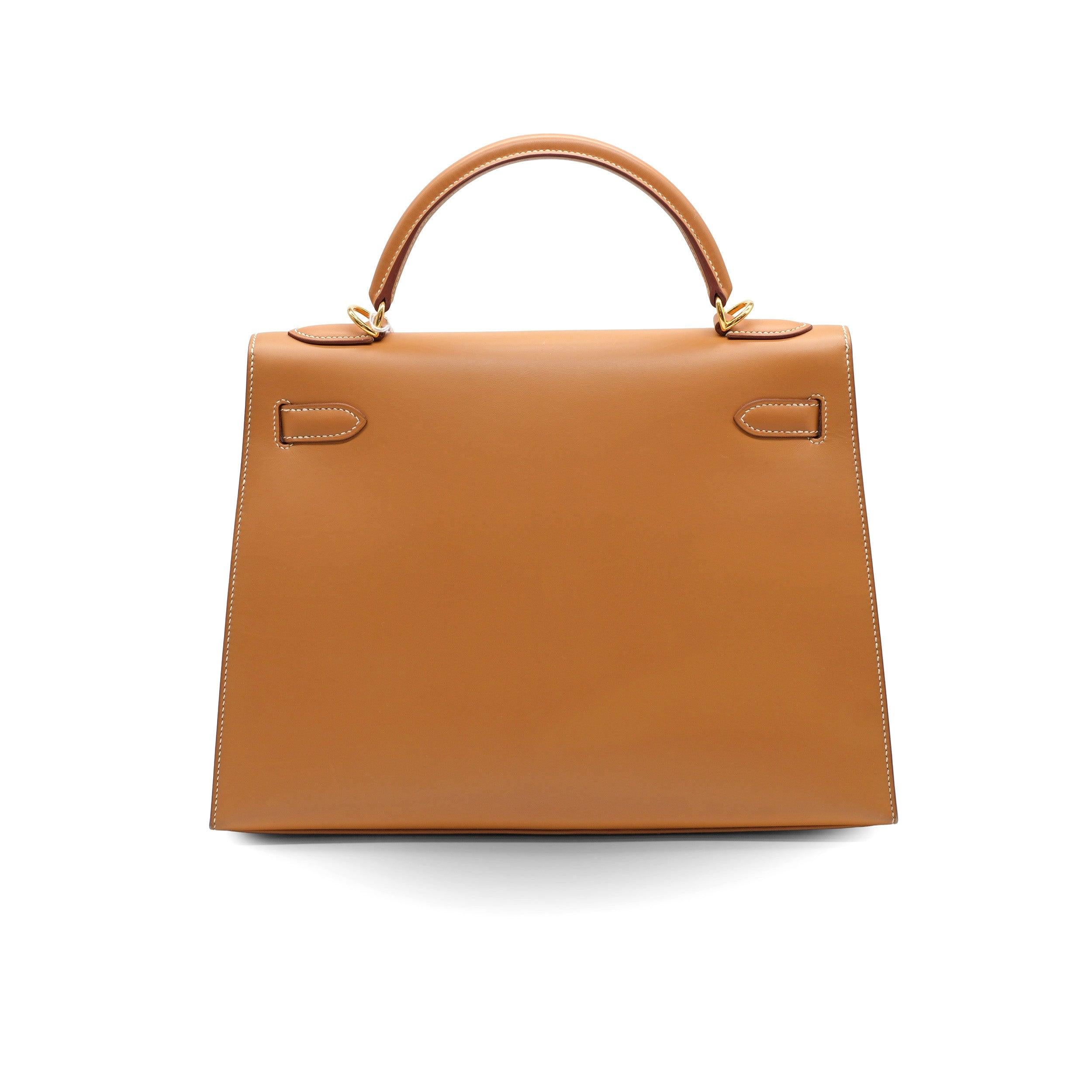 Introducing the iconic Kelly 32 by Hermes in a glamorous brown tone with gold hardware. Crafted with the highest quality materials and meticulous attention to detail.
 The bag's neutral colour and gold hardware make it a versatile and luxurious