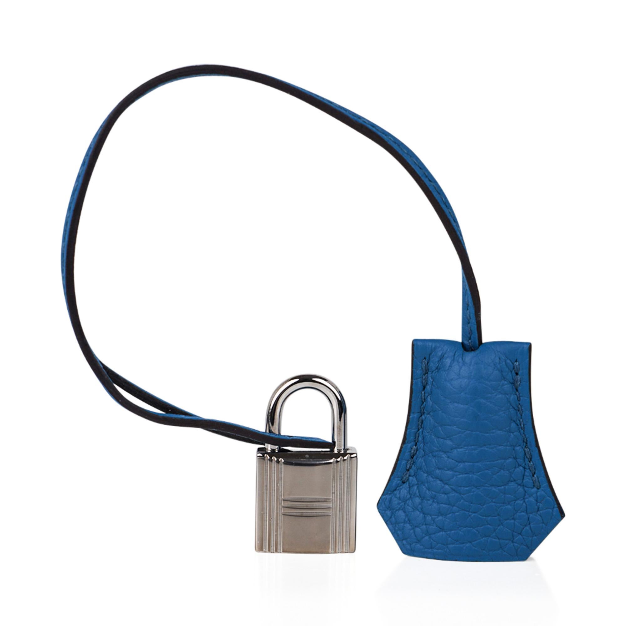 Guaranteed authentic Hermes 32 Kelly in vibrant Mediterranean Blue Izmir.
Lush Clemence leather is highly scratch resistant.
Fresh Palladium hardware.
Clean corners, body, handle and interior.  Minor marking on hardware..
Comes with strap, raincoat,