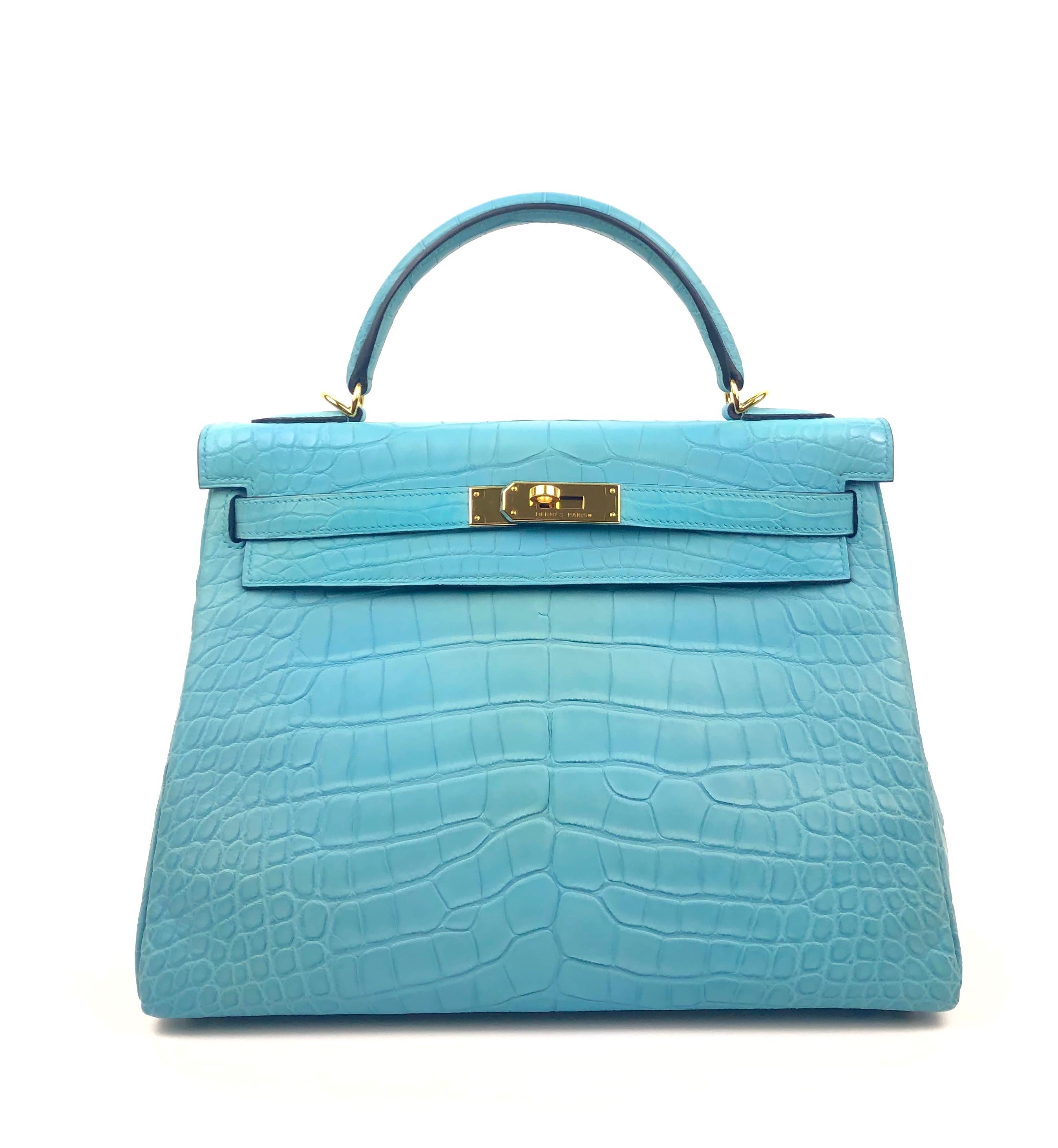 HERMES KELLY 32 BLUE ATOLL MATTE ALLIGATOR MISSISSIPPIEN CROCODILE.
Pristine Condition, Plastic on Hardware. T Stamp 2015.

Shop with Confidence from Lux Addicts. Authenticity Guaranteed!