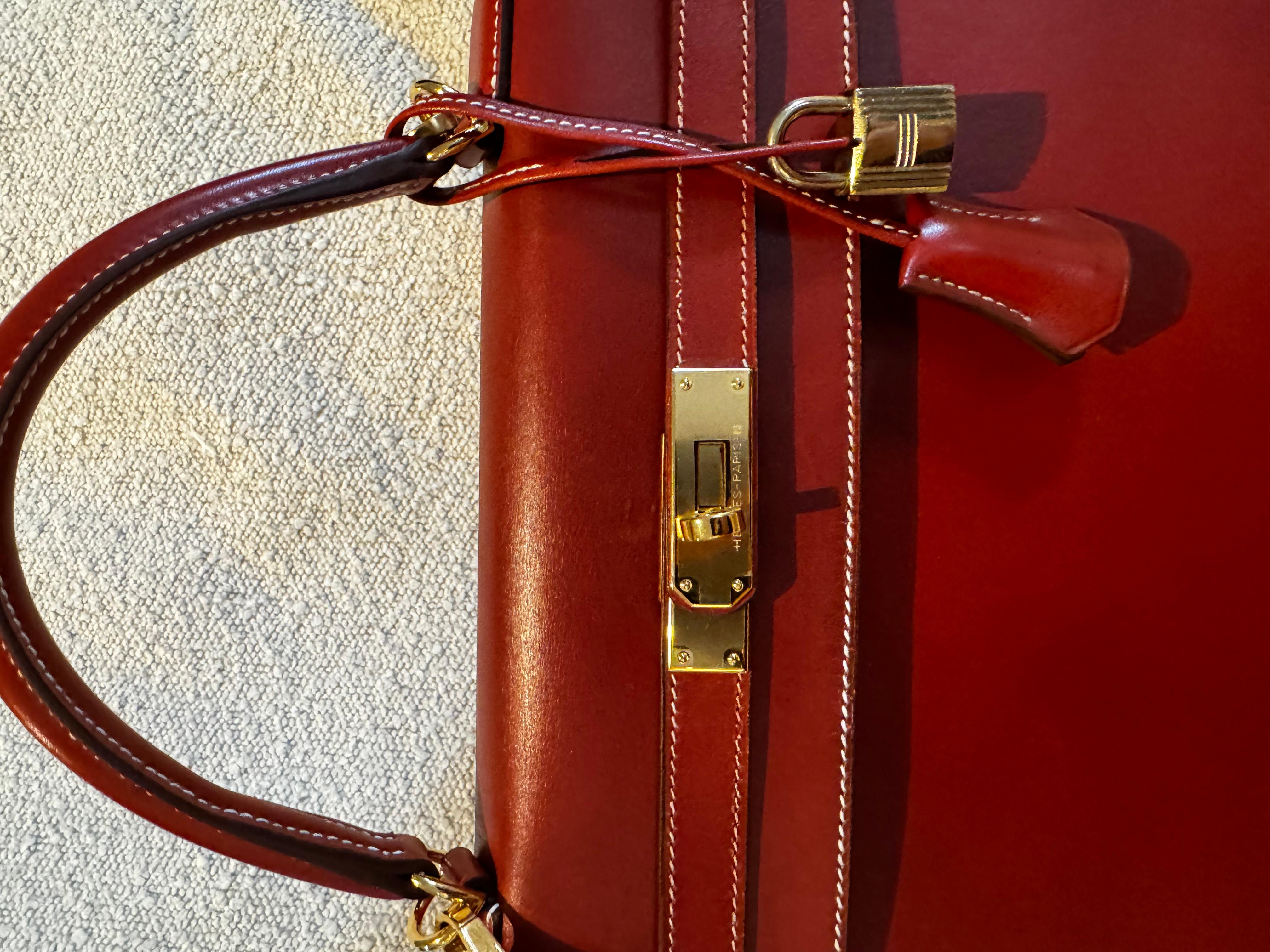 Hermes Kelly 32 sellier vintage in burgundy box leather with gold hardware. Recently relaunched colour and leather combo, very popular and desirable. With new hardware and new handle, just out of the Hermes repair service. 
Comes with its shoulder