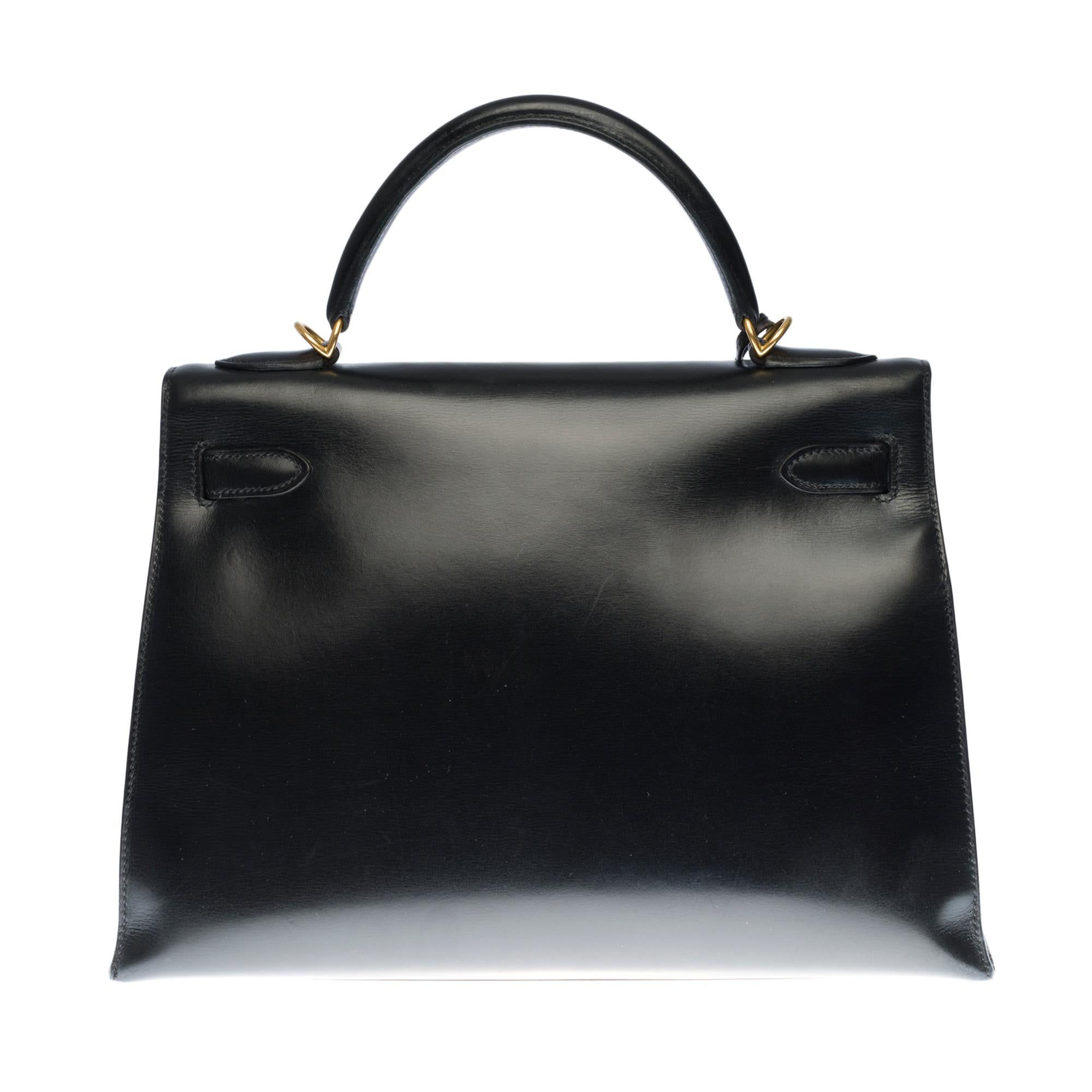 Rare & Exceptional Hermes Kelly 32 sellier handbag with shoulder strap in black box leather, gold plated metal hardware, simple handle in black box leather , a removable shoulder strap handle in black box leather allowing a hand or shoulder