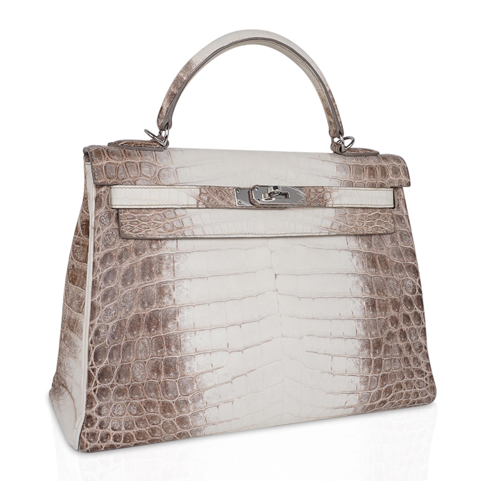 Mightychic offers an Hermes Kelly 32 bag featured in coveted Limited Edition Himalaya crocodile.
This Hermes Kelly 32 bag is amongst most rare in the Himalayan bags produced by Hermes.
Fresh with palladium hardware.
Comes with Hermes signature box,