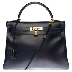 Used Hermès Kelly 32 retourné handbag with strap in Navy blue calf leather, GHW