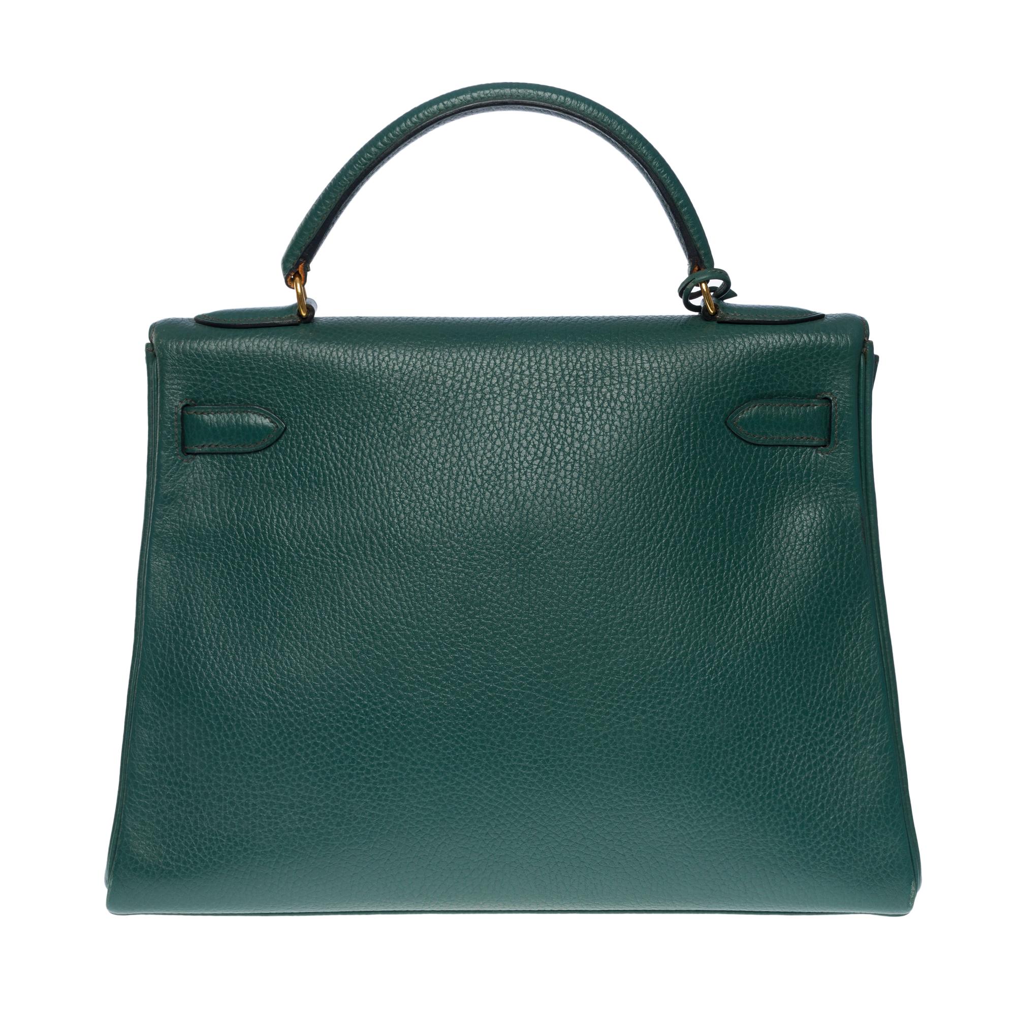 Rare and in one of the most precious leathers of the house Hermès: Hermes Kelly 32 handbag returned strap in Vert Malachite Vache Ardennes leather, gold plated metal hardware, green leather handle, removable shoulder strap in green leather allowing
