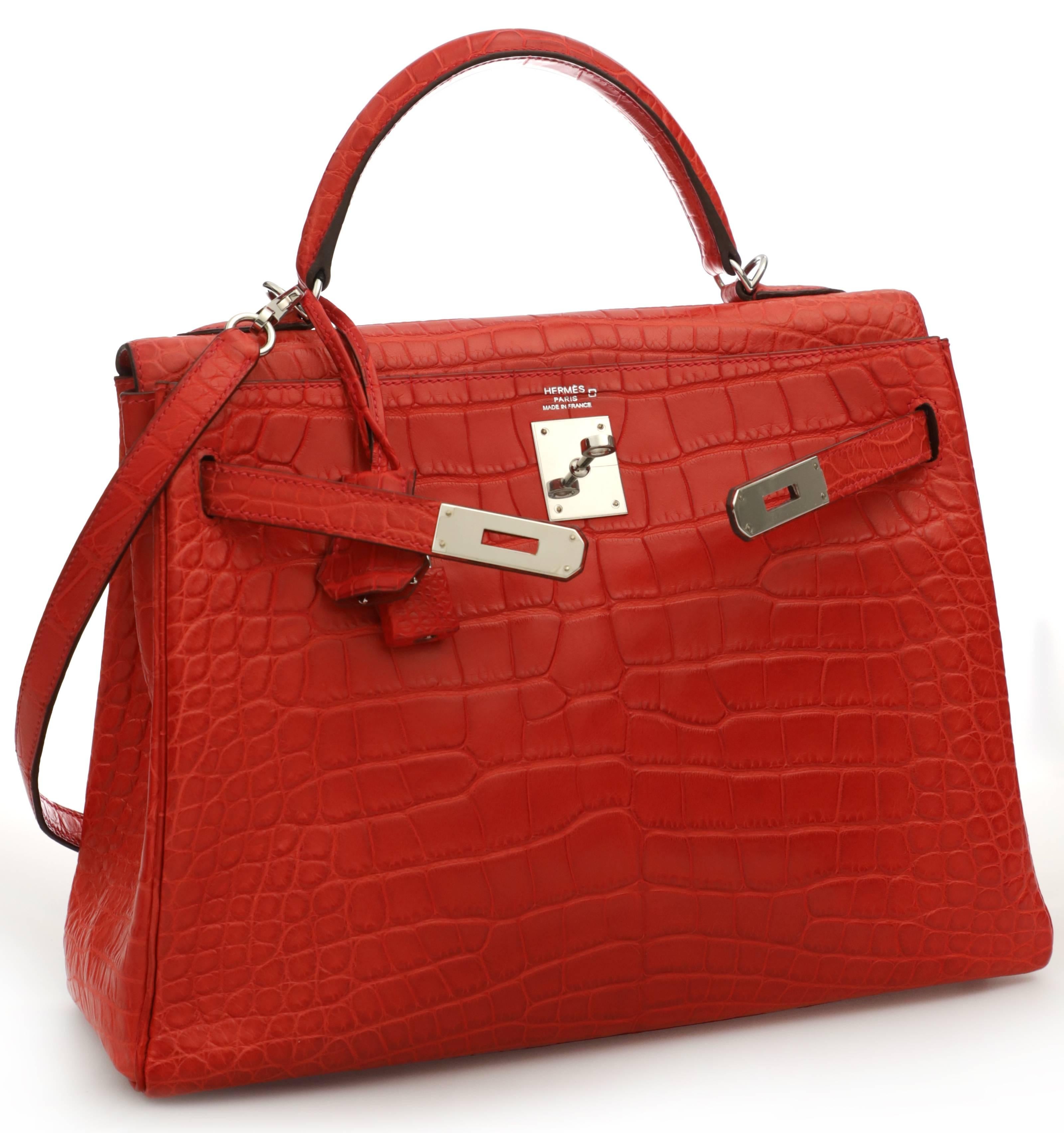 HERMES Kelly 32 rouge pivoine alligator mat with palladium hardware. Appears to have been used a few times. The hardware still features plastic protections and is in excellent condition. Feet don't show plastic protection and are slightly scuffed.