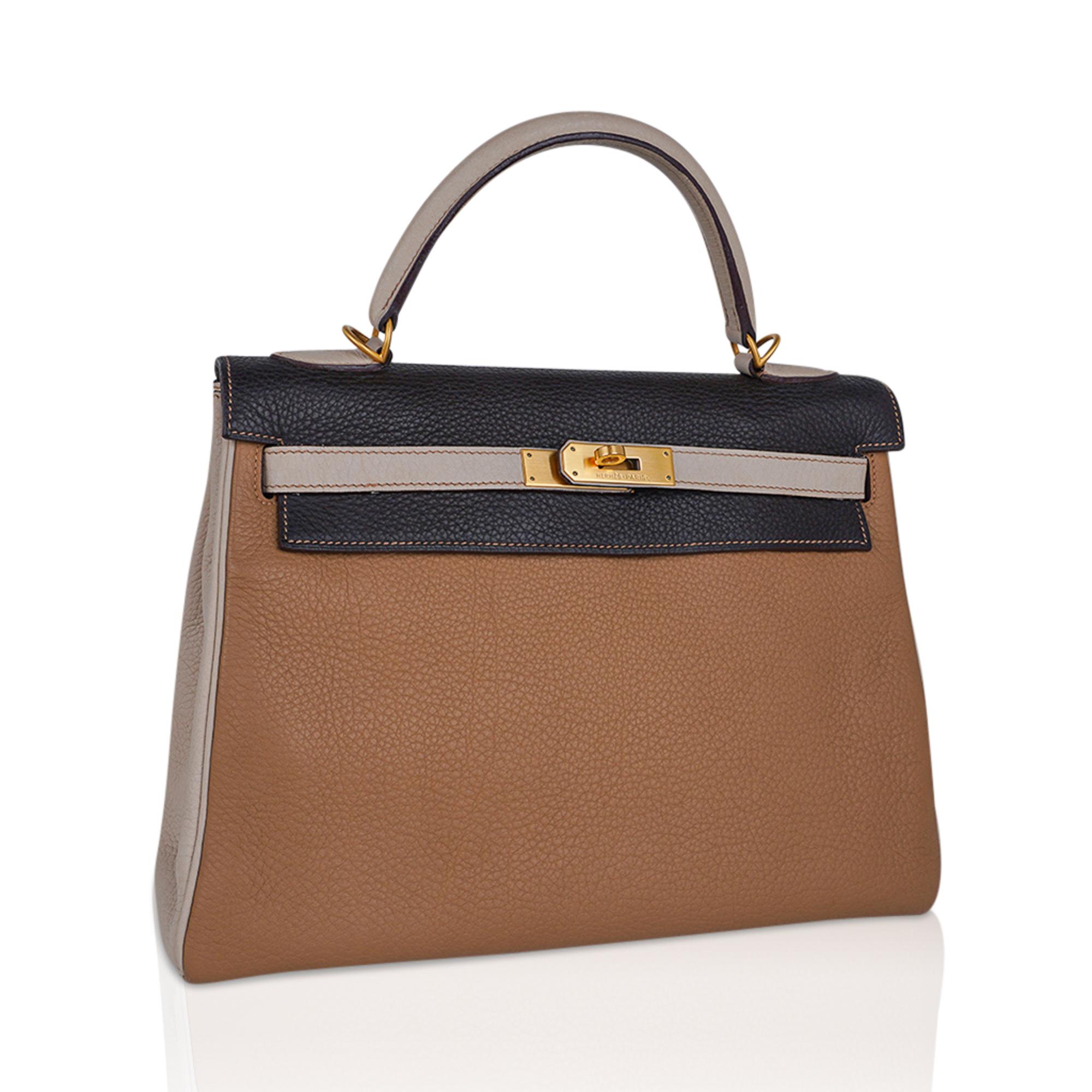 mightychic offers a Limited Edition  Hermes Kelly 32 Tri-color vintage bag featured in Tabac Camel, Ebene and Parchemin.
This gorgeous and rare special order tri color Kelly bag is rich in neutral earth tones.
Accentuated with brushed Gold