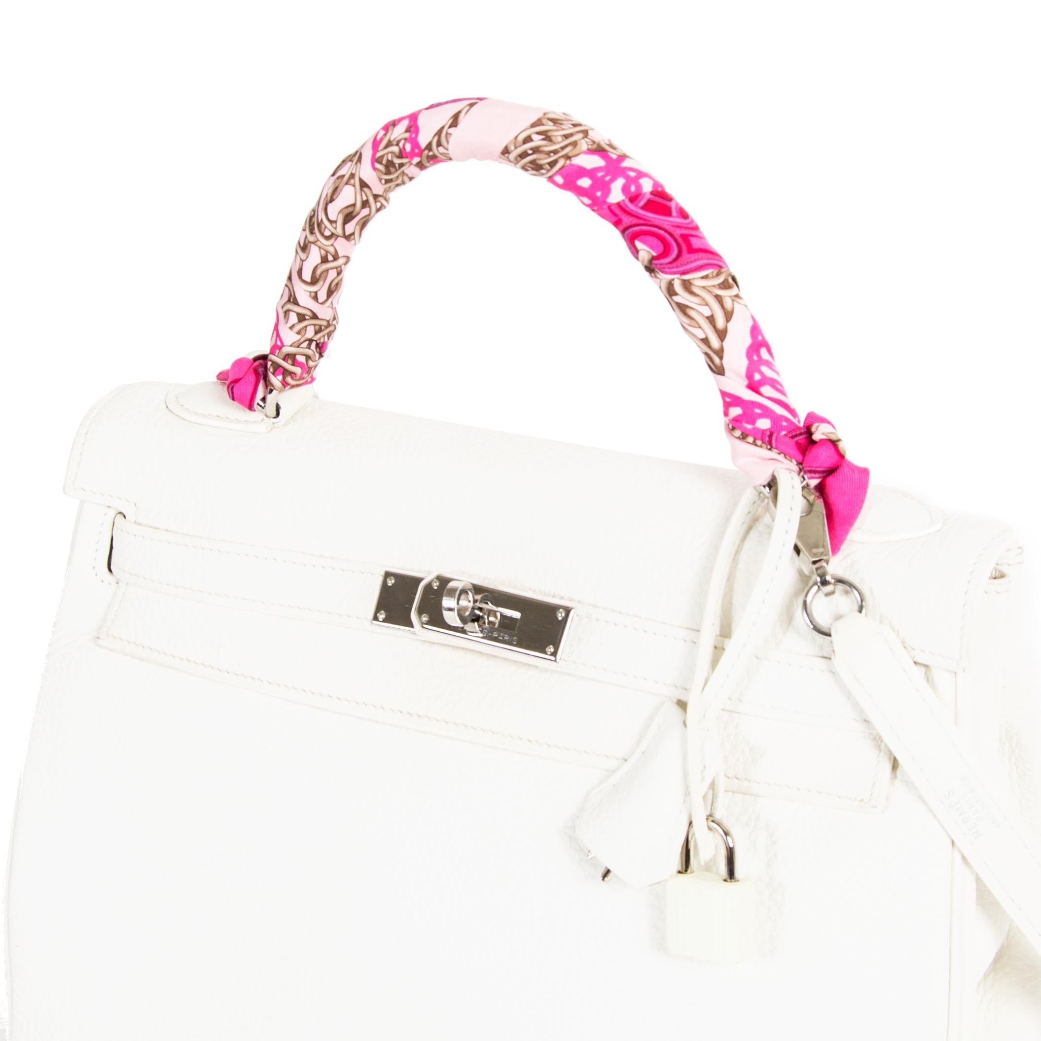 Hermès Kelly 32 White Togo PHW in very good condition. This ultimate classic bag is crafted from Clemence Taurillon leather, which is known to be very durable. The pebbled leather comes in a stunning white hue, which complements the gorgeous