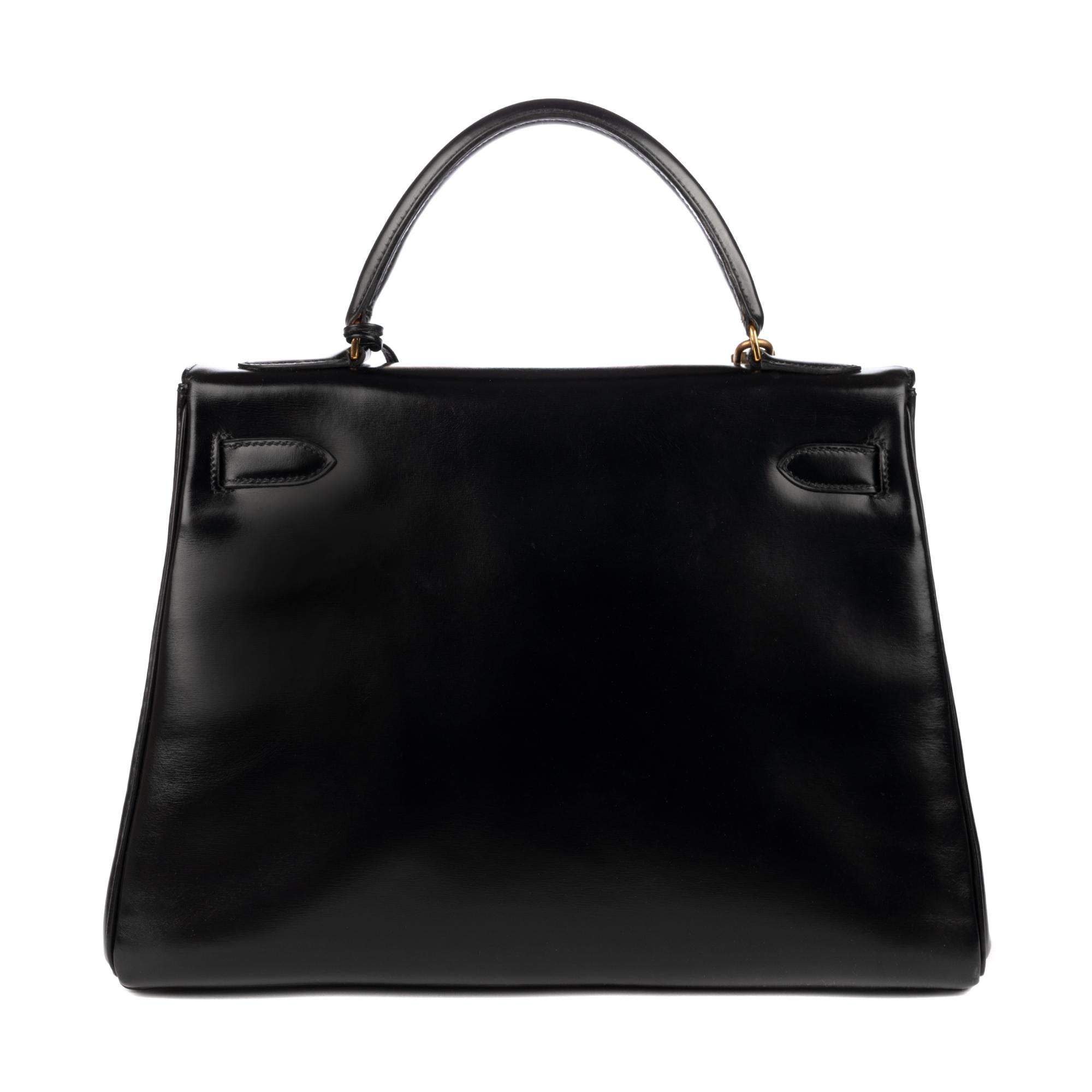 The Hermes Kelly back 32 cm
 bag in black box leather, gold metal hardware
, single handle in black leather, removable shoulder strap new (not signed Hermes) in black leather for hand or shoulder worn.  Flap closure.  Inner lining in black leather,