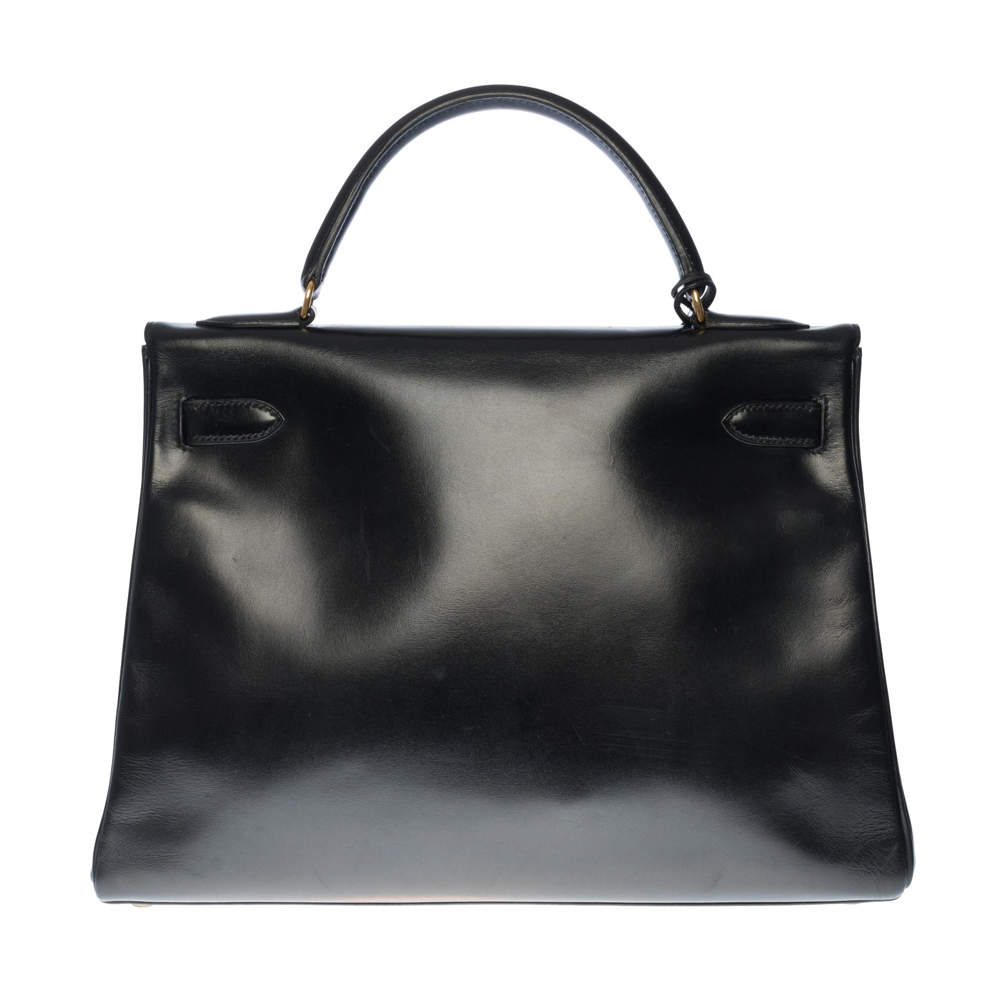 Gorgeous Hermes Kelly 32 retourné in black box calf leather Shoulder Bag with strap, Gold Plated Metal hardware, black leather handle, Removable black leather Shoulder Strap for Hand or Shoulder Support.

Closure by flap.
Lining in black leather,