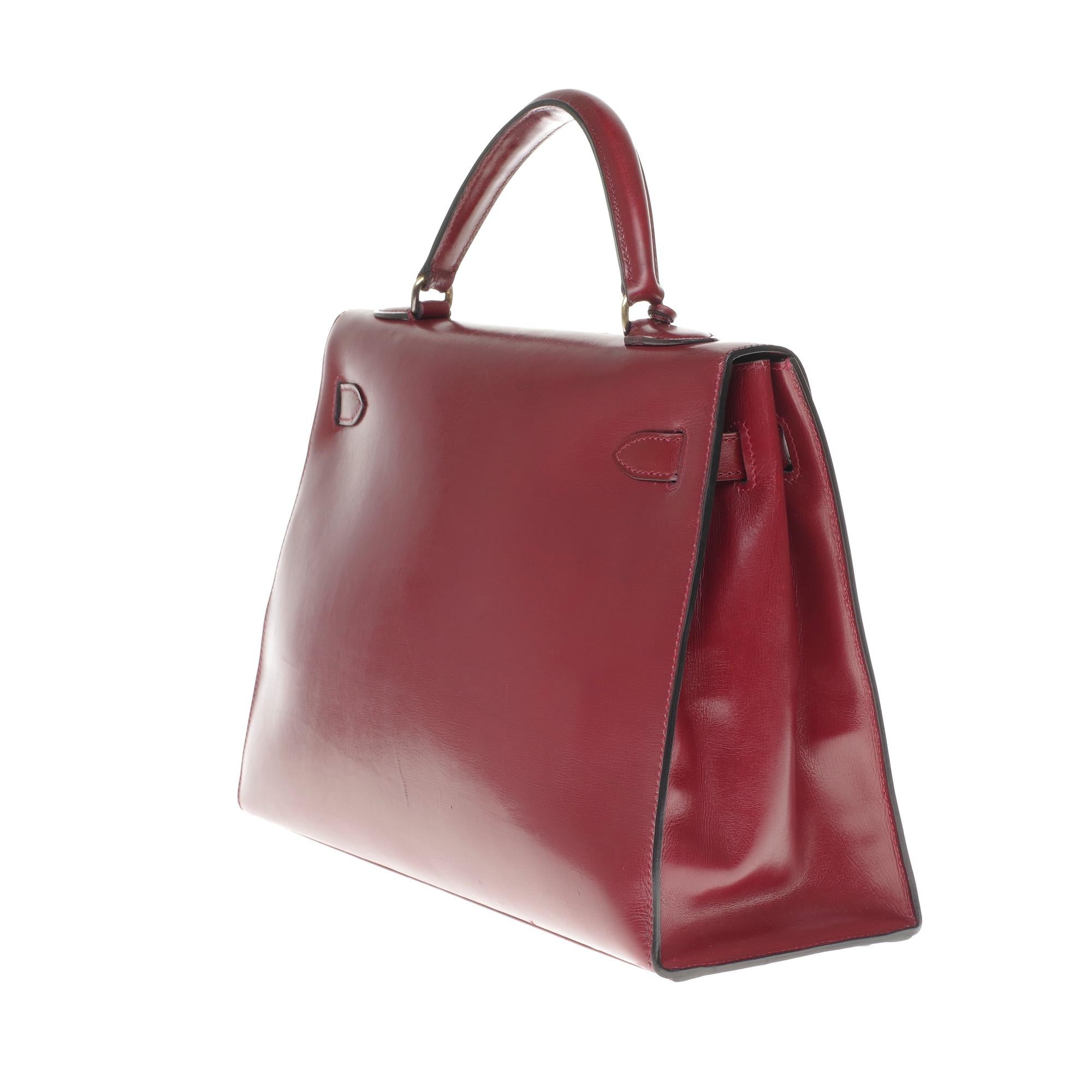 Women's Hermès Kelly 32cm sellier handbag with strap in burgundy calfskin, gold hardware