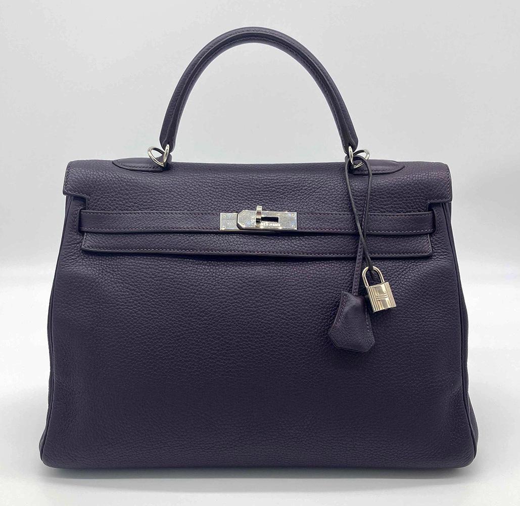 Hermes purple raisin kelly 35 in excellent condition. Deep purple raisin clemence leather exterior trimmed with silver palladium hardware. Signature twist lock double strap top flap kelly closure opens to a matching purple leather interior with one
