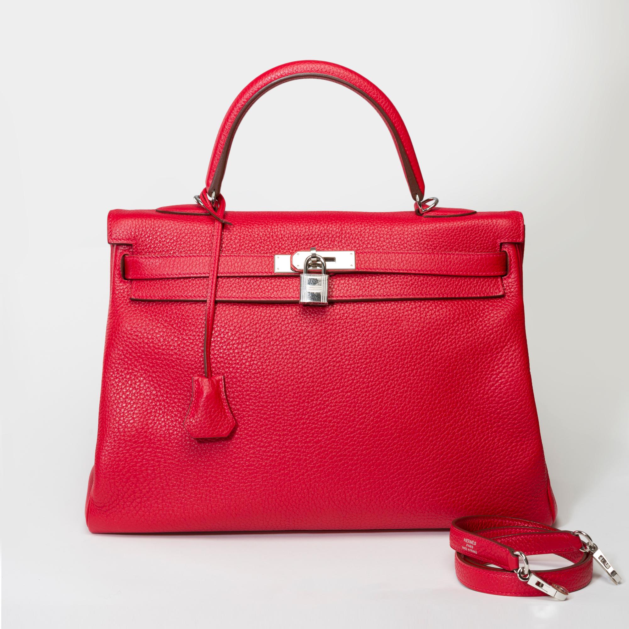 Bright Hermes Kelly 35 retourne handbag strap in Red Taurillon Clemence leather, palladium silver metal hardware, red leather handle, removable leather handle in red Taurillon Clemence for hand, shoulder or crossbody carry

Flap closure
Red leather