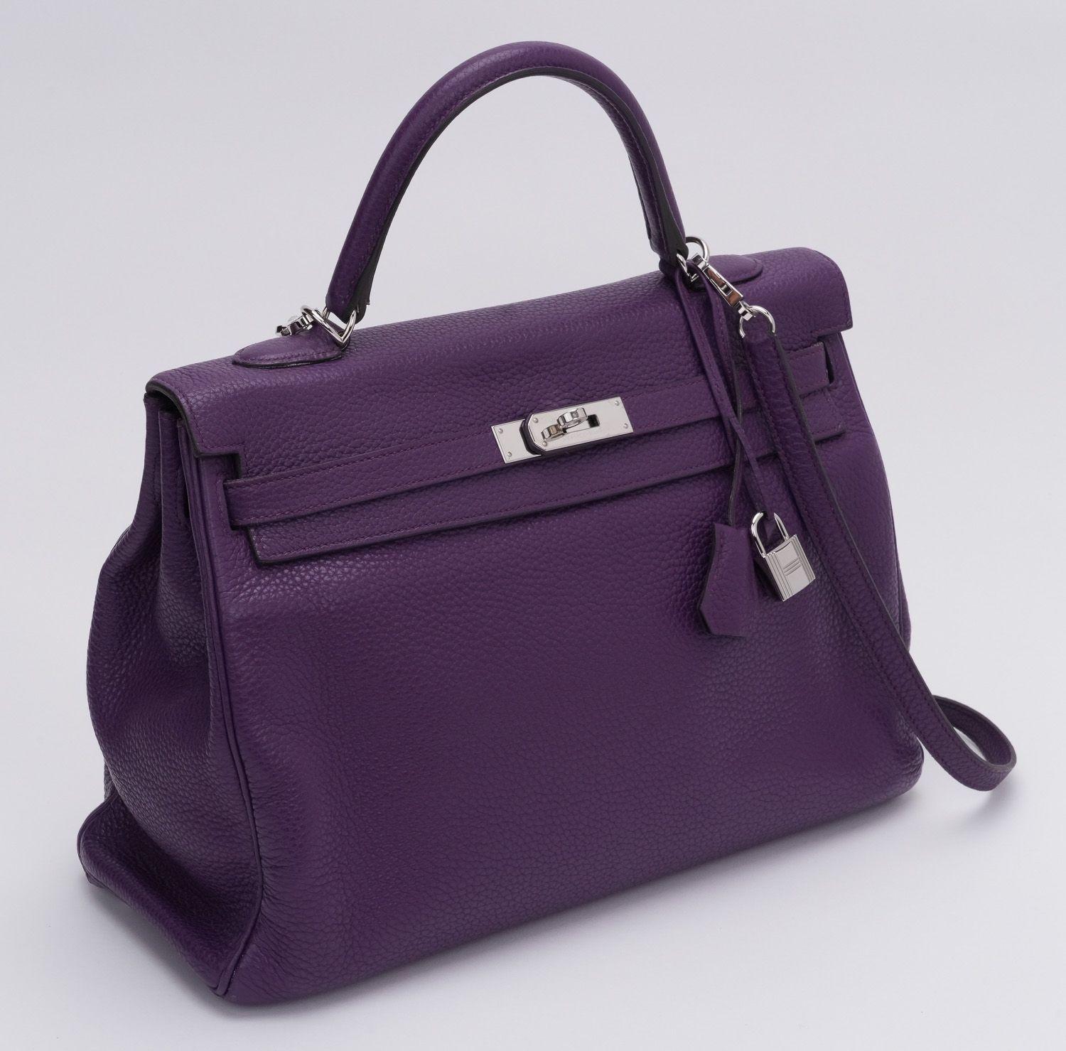 Hermès Kelly 35 retournein clemence leather in the color ultraviolet. The bag is in excellent condition and comes with a small and large dust cover, strap and the rain jacket. The drop of the handle is 4' and the strap is 17.5' long.