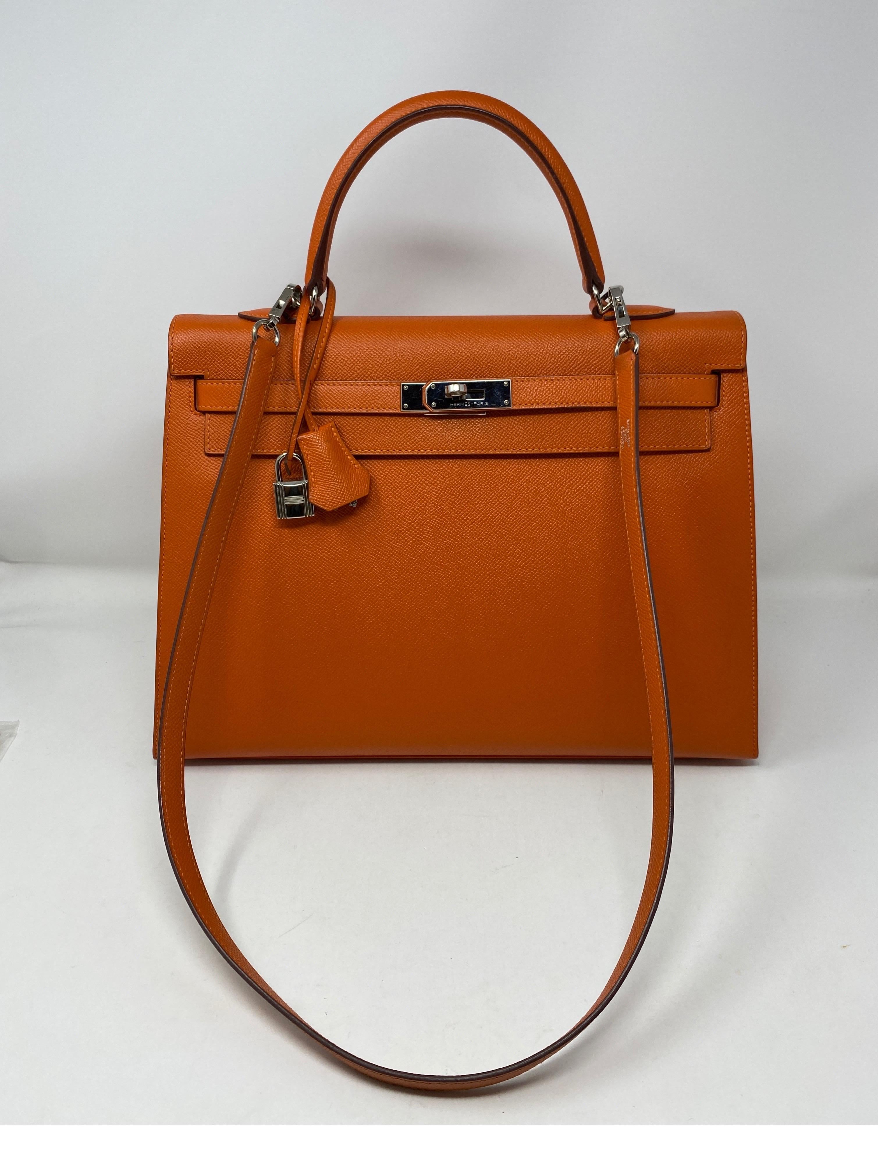 Hermes Feu Orange Kelly 35 Sellier Bag. Mint like new condition. Plastic is still on hardware. Palladium hardware. Very hard to find sellier Kelly bag. The bag stays up no slouch. Great look. Most are retourne. This one is a collector's piece.