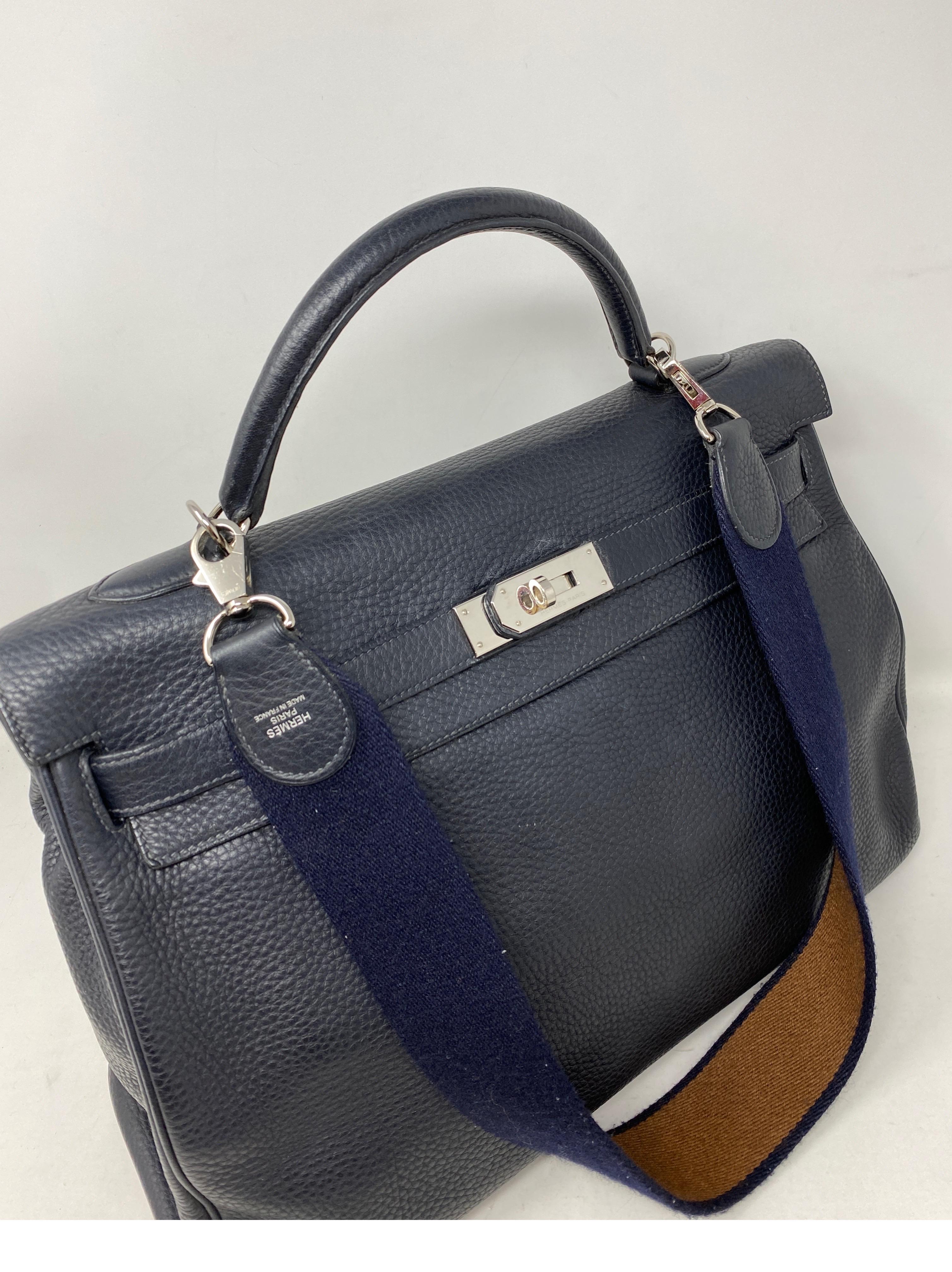 Hermes Kelly 40 Blue Indigo Bag. Palladium hardware. Navy and tan canvas strap. Good condition. Large size Kelly bag. Can be worn with or without strap. Includes clochette, lock, keys and dust cover. O stamp. Guaranteed authentic. 