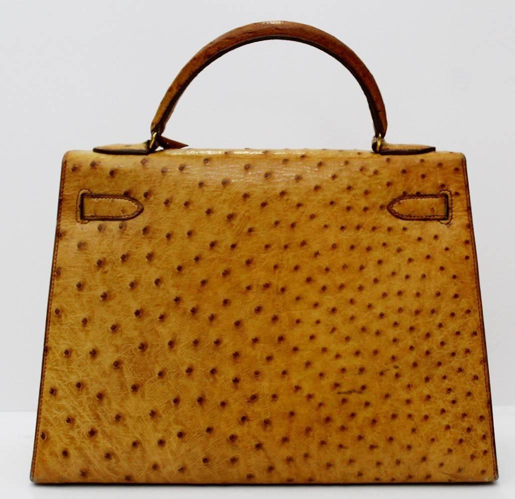 Hermes Vintage Kelly in gold ostrich leather. Featuring gold-plated hardware this beautiful bag comes with its original lock and key and dust bag. The interior has one zipped pocket and two open pockets