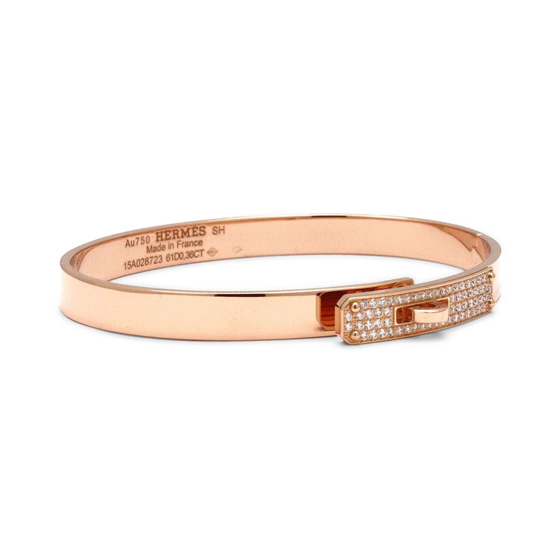 Authentic Hermès 'Kelly' bracelet crafted in 18 karat rose gold and accented with round brilliant cut diamonds weighing approximately 0.36 carats. It's fastener, a turn clasp, is synonymous with the brand. Signed Hermes Paris, Au750, Made in France,