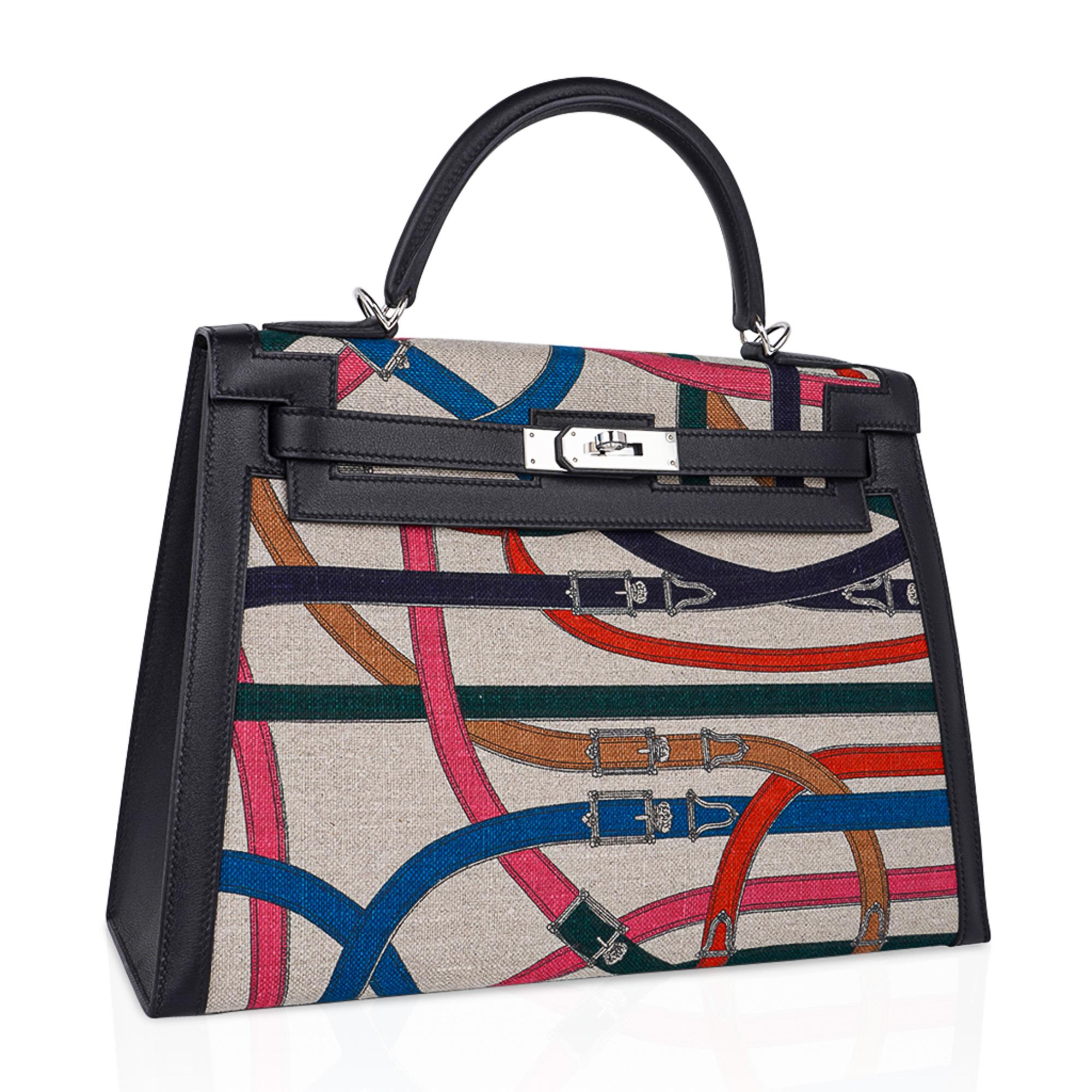 Mightychic offers an Hermes Kelly Sellier Cavalcadour  32 bag.
This striking Limited Edition Kelly bag is featured in washed Toile de Camp and and black swift leather.
Each one of these extremely limited production beauties has a unique one of kind
