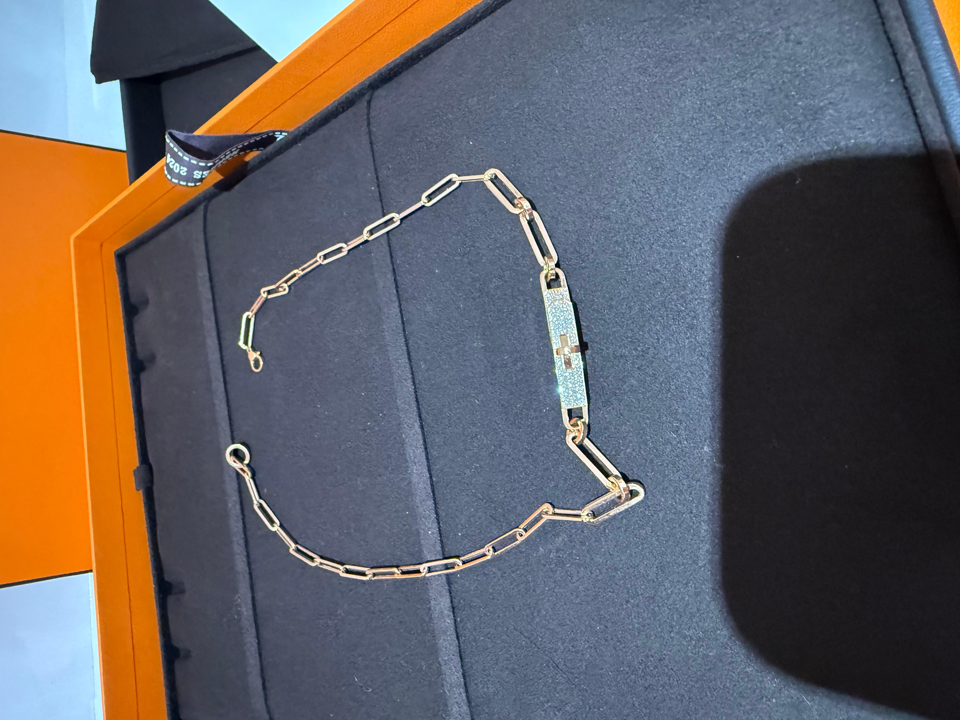 Hermes Kelly Chaine Choker Necklace 18K Rose Gold and Diamonds. The necklace is crafted of 18 karat rose gold and features the signature Kelly clasp motif pave-set with round brilliant cut diamonds, approximately .62 total carat weight. 16 inch