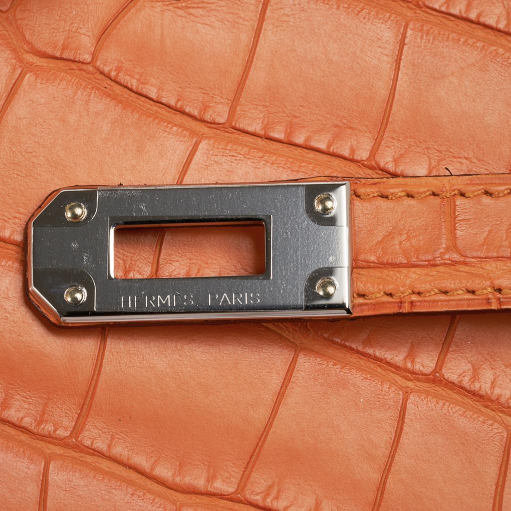 Guaranteed authentic Hermes Kelly Classic Long (Longue) wallet featured in rare Abricot matte alligator. 
Often carried as a clutch, this Kelly wallet beauty is a jewel in your hand.
Kelly Cadena zipper pull.  
Twelve (12) credit slots. 
Two (2)