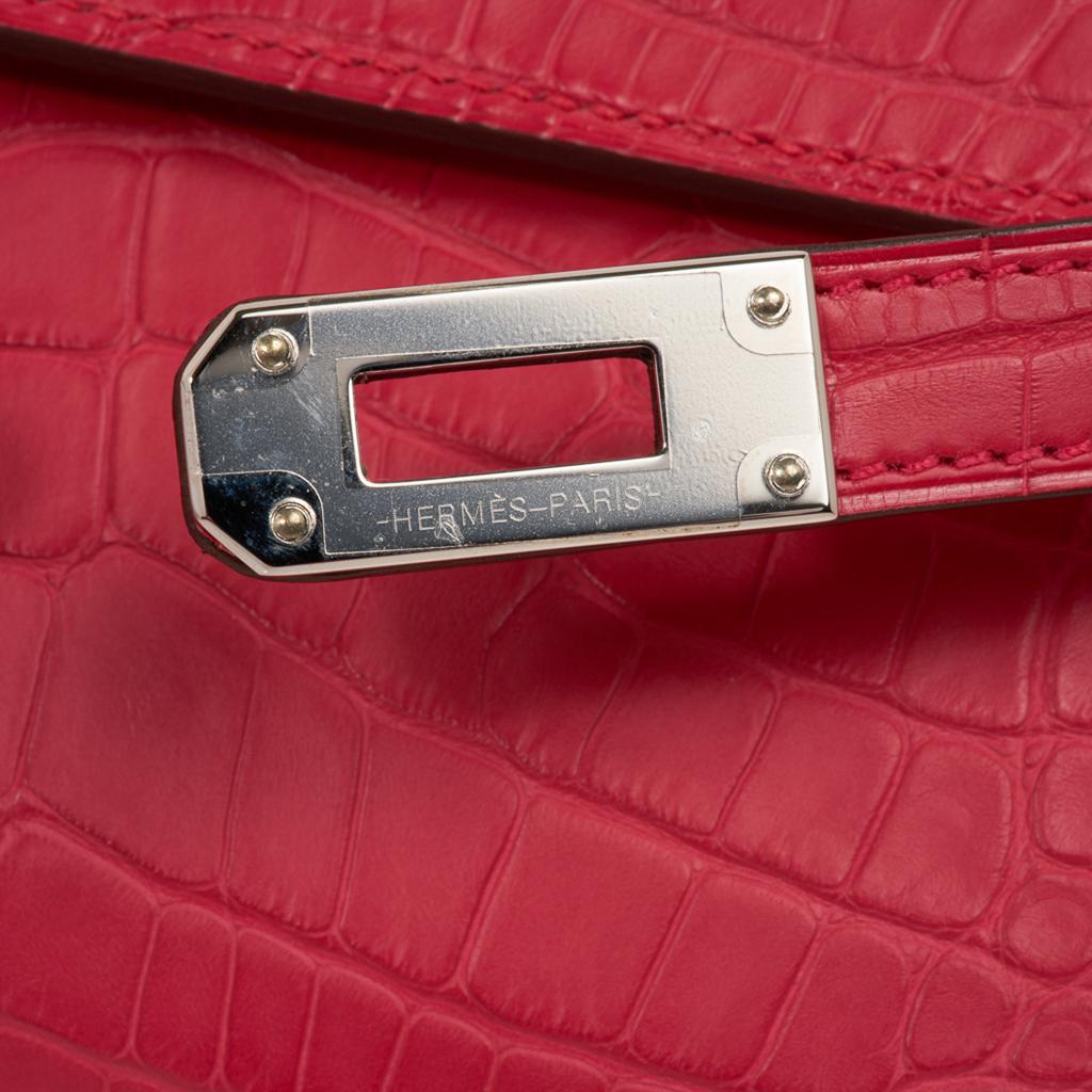 Guaranteed authentic Hermes Kelly Classic Long (Longue) wallet featured in vivid Rose Extreme matte Alligator. 
Often carried as a clutch, this Kelly wallet beauty is a jewel in your hand.
Kelly Cadena zipper pull. 
Twelve (12) credit slots. 
Two