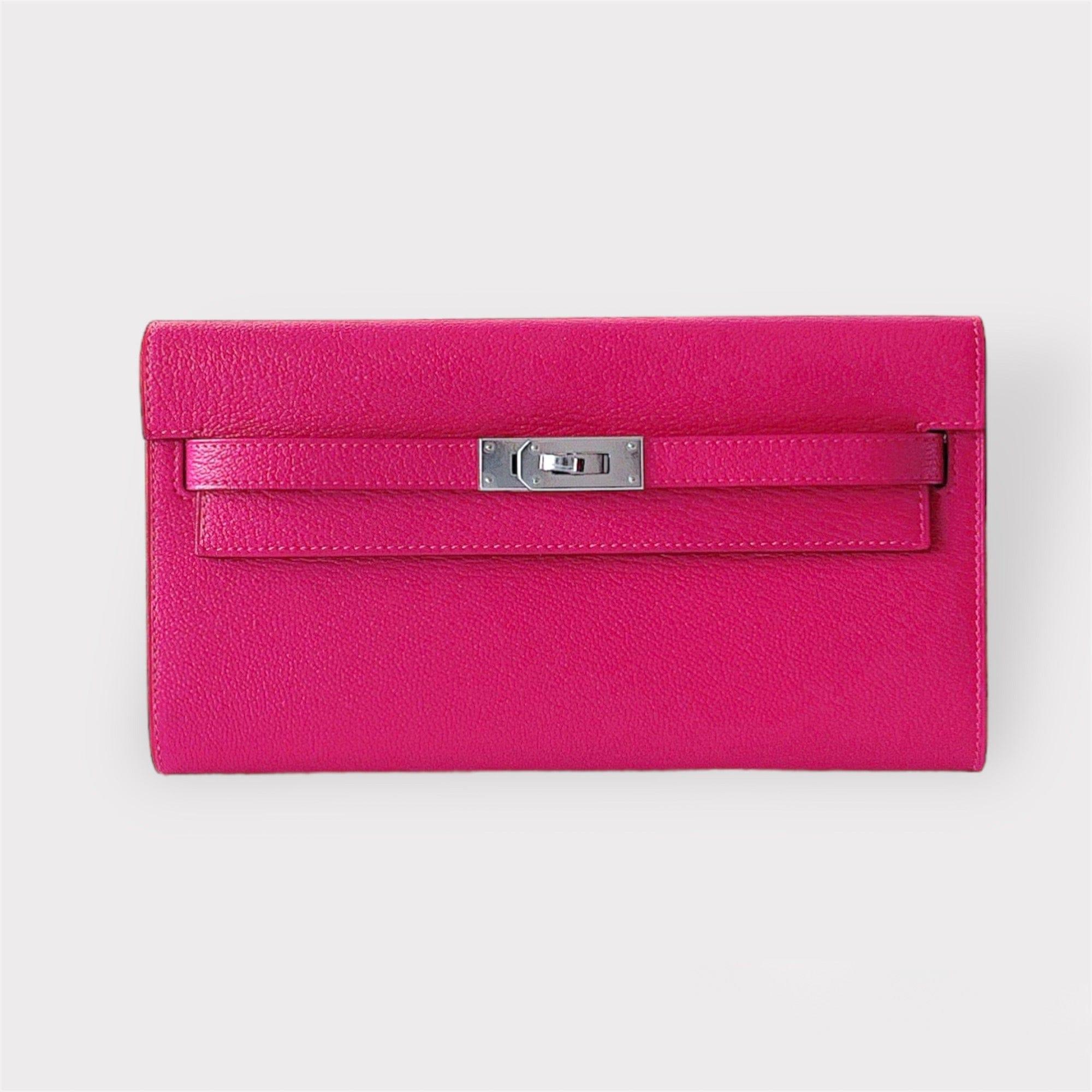 Shop this eye catching Hermes Kelly Classique To Go Wallet, In Rose Mexico, Pink With Palladium Hardware. It is crafted in Epsom Leather and comes with a strap which makes the wallet usable as both a clutch and a bag. There are 

4 credit card slots