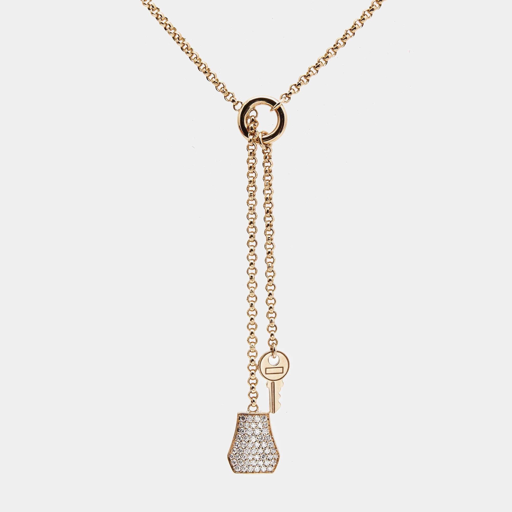 The Hermès Kelly necklace is a stunning piece of jewelry that embodies elegance and luxury. Crafted with exquisite attention to detail, this necklace features a delicate clochette pendant adorned with sparkling diamonds suspended from a lustrous 18k