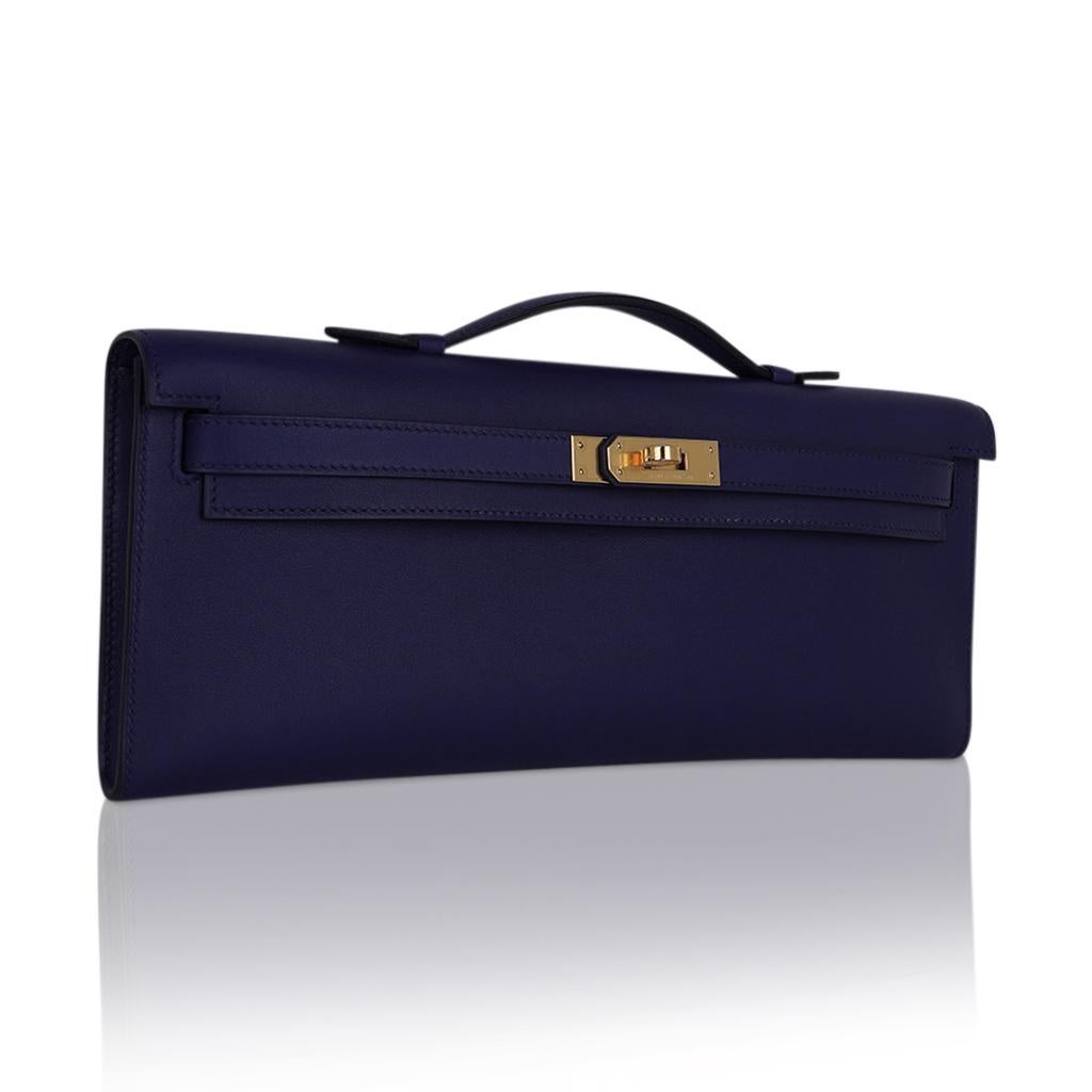 Mightychic offers a timeless Hermes Kelly Cut bag featured in jewel toned Blue Encre.
This rich blue Hermes clutch is perfect day to evening. 
Swift leather. 
Lush with Gold hardware.  
NEW or NEVER WORN.   
Comes with sleeper and Hermes box and