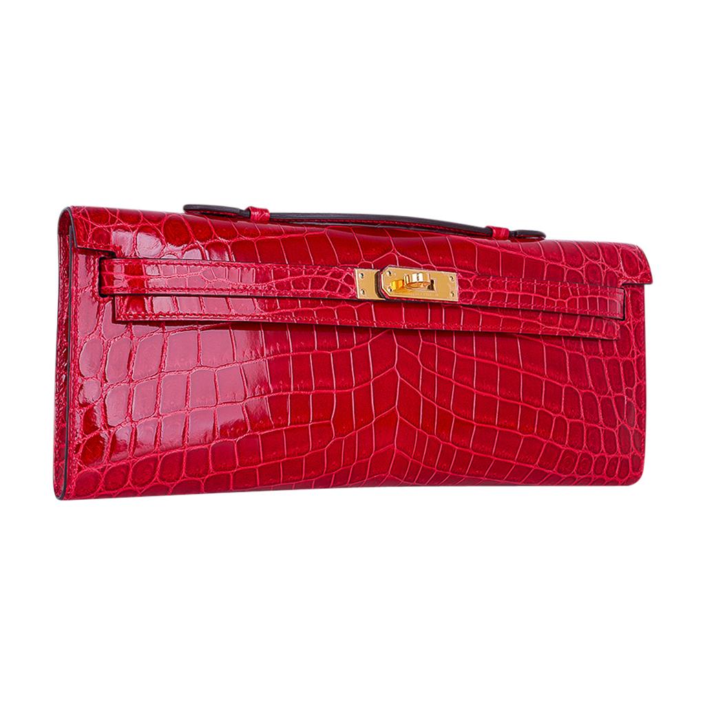 Mightychic offers a timeless Hermes Kelly Cut bag featured in vivid Braise Niloticus Crocodile.
This exquisite lipstick red Hermes clutch is perfect day to evening. 
Lush with Gold hardware.
Comes with sleeper and signature Hermes box with ribbon.