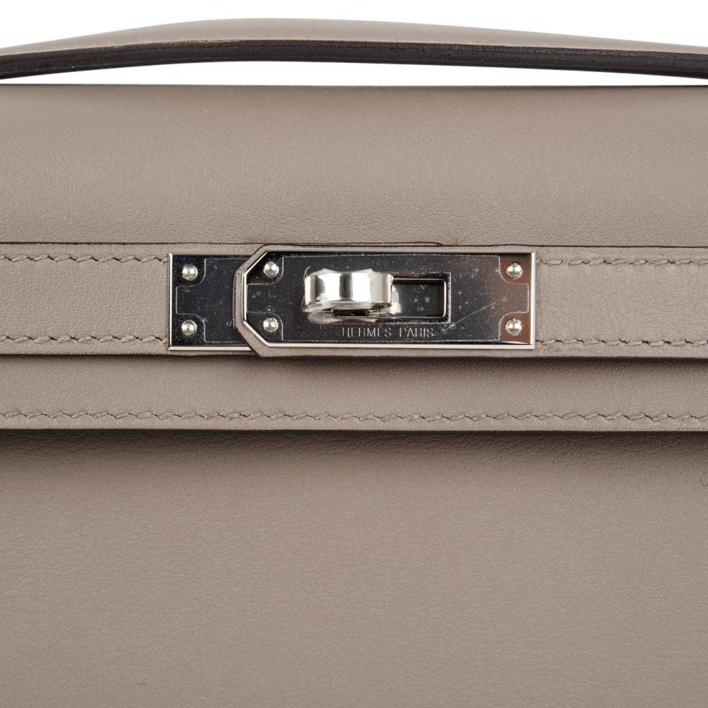 Guaranteed authentic Hermes Kelly Cut in the understated elegance of Gris Asphalt - the perfect gray hue.
Fresh palladium hardware.
Swift leather. 
Comes with box, sleeper and signature Hermes box.  
NEW or NEVER WORN. 
final sale

BAG